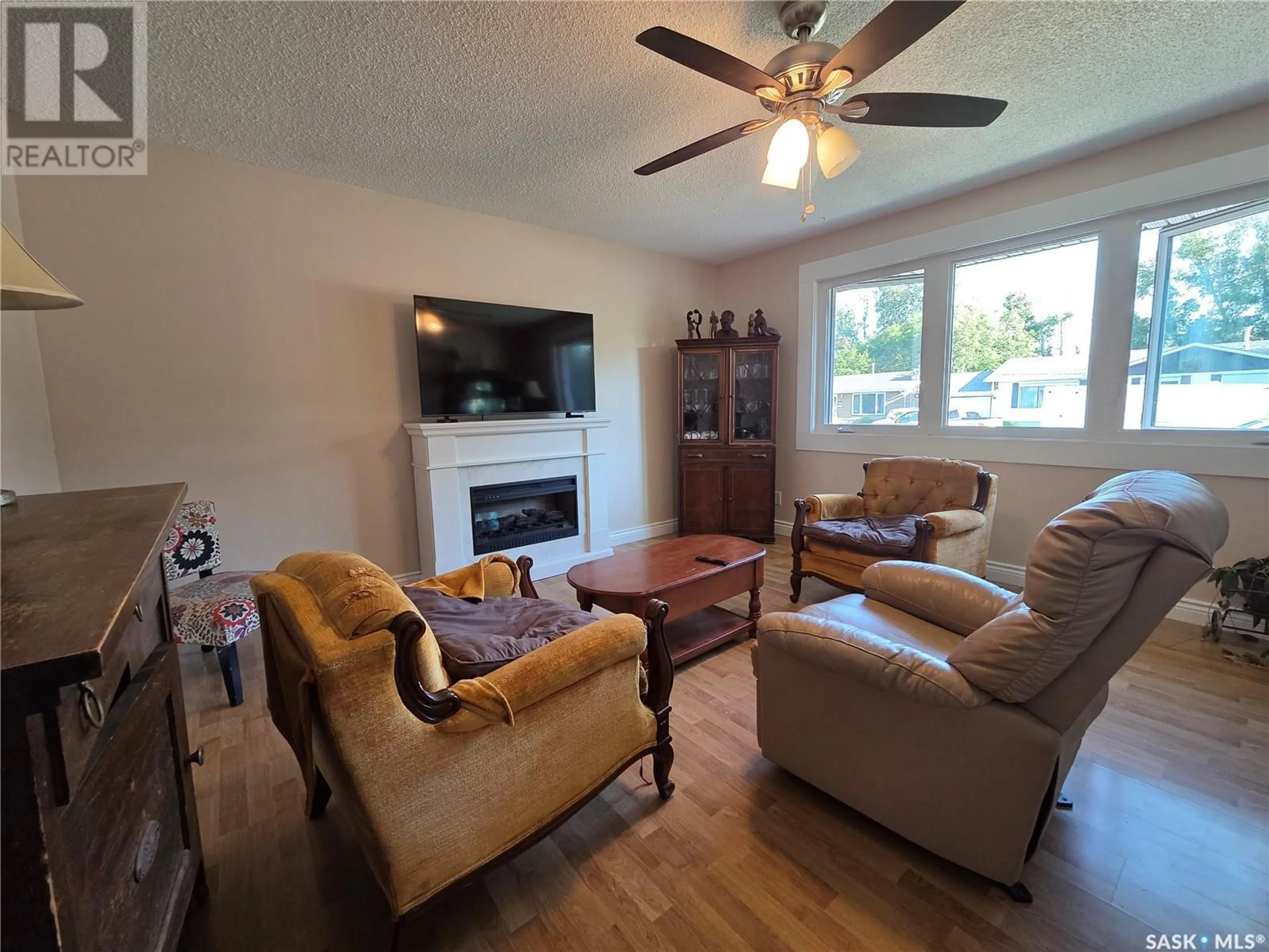 Living room with furniture, wood/laminate floor for 119 SYLVITE CRESCENT, Allan Saskatchewan S0K0C0