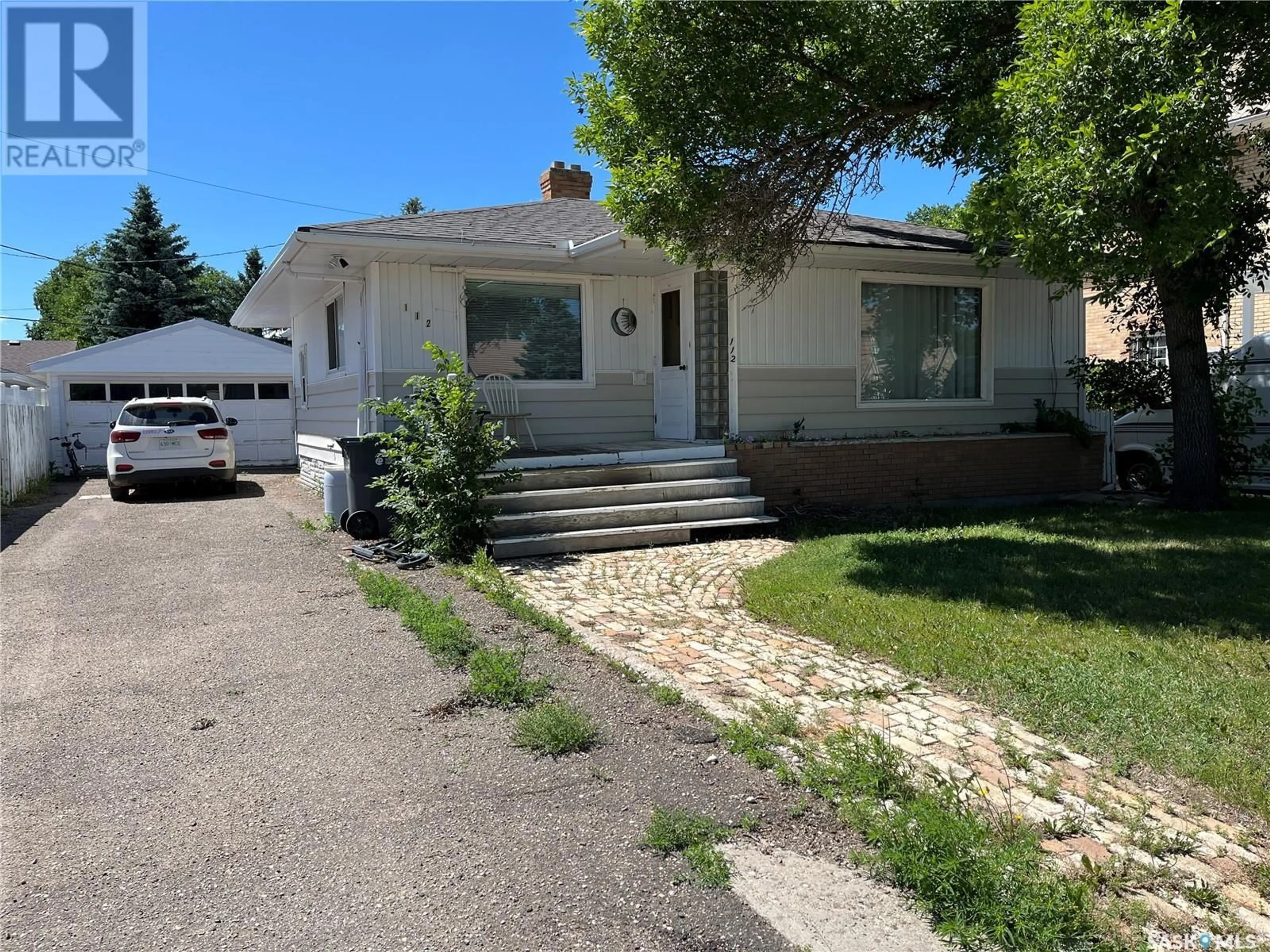 Home with vinyl exterior material, street for 112 2ND AVENUE, Gravelbourg Saskatchewan S0H1X0