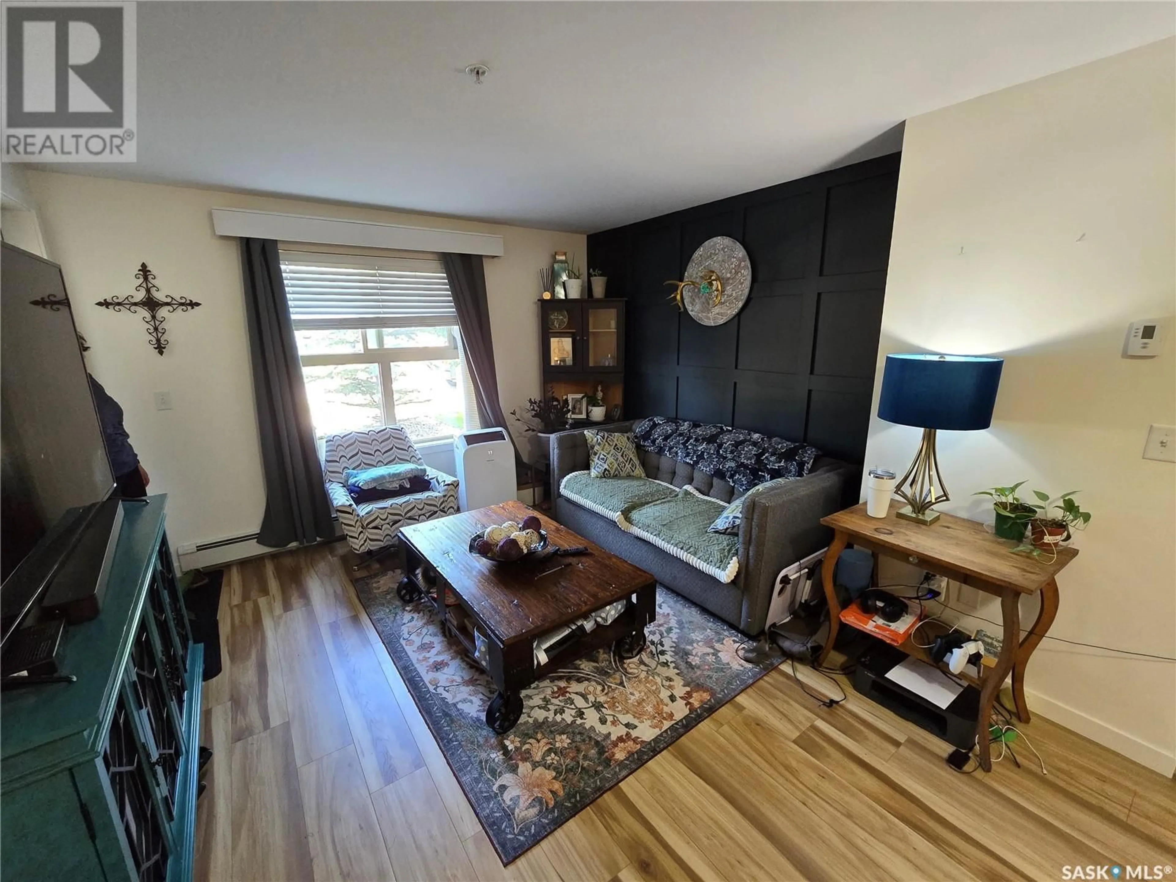 Living room with furniture, wood/laminate floor for 2000-5500 - 2107 MITCHINSON WAY, Regina Saskatchewan S4W0N9