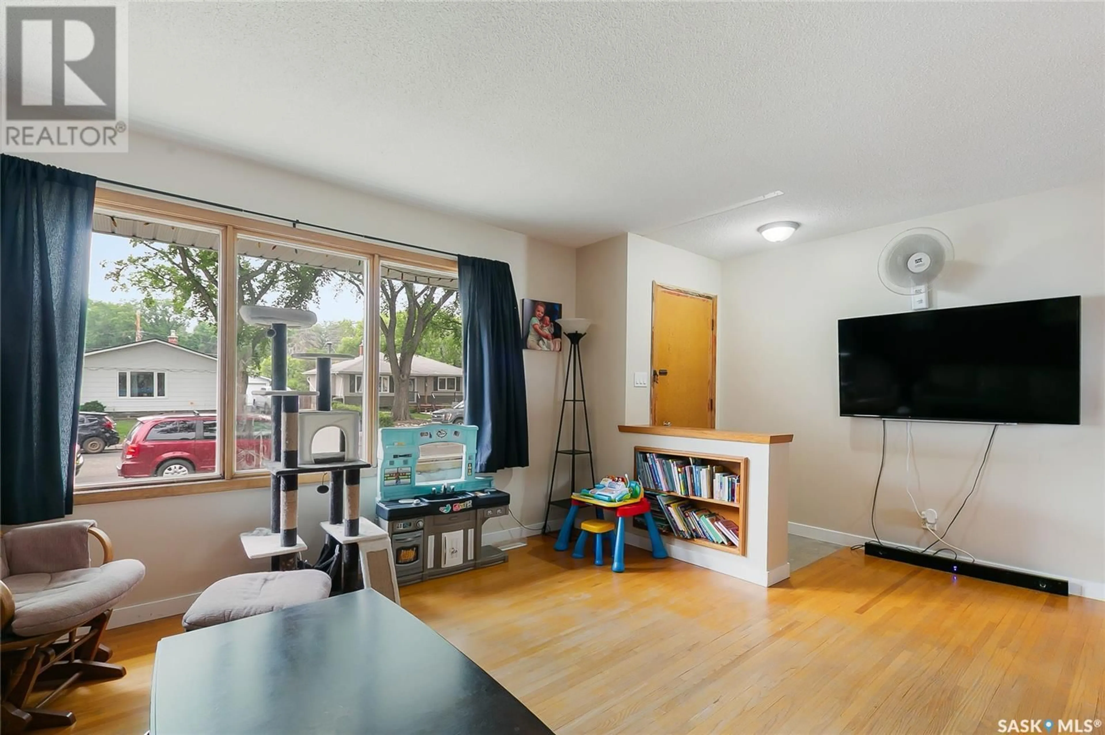 Living room with furniture, wood/laminate floor for 35 LAIRD CRESCENT, Regina Saskatchewan S4R4N7