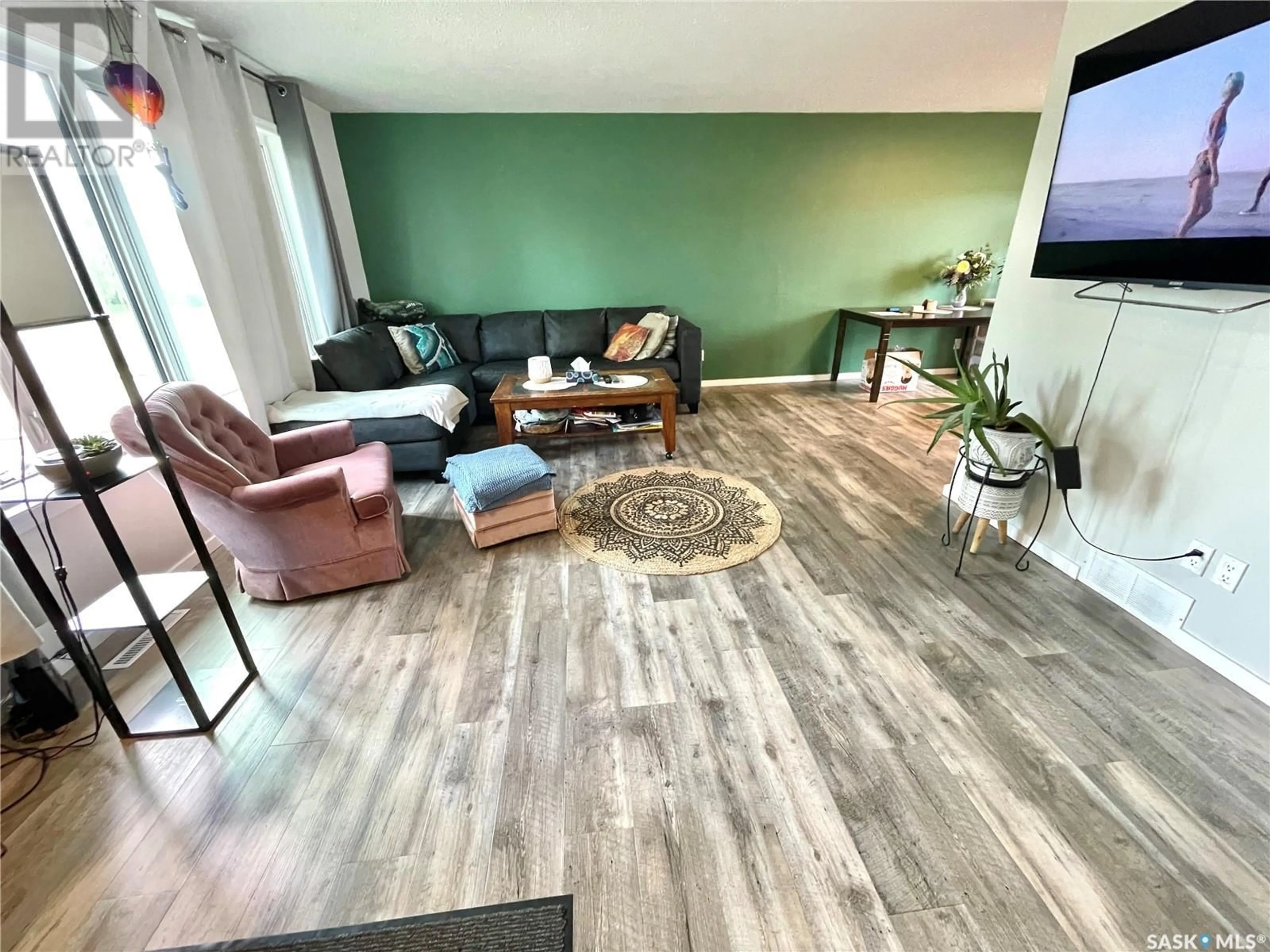Living room with furniture, wood/laminate floor for 10205 CAMPBELL CRESCENT, North Battleford Saskatchewan S9A3S3