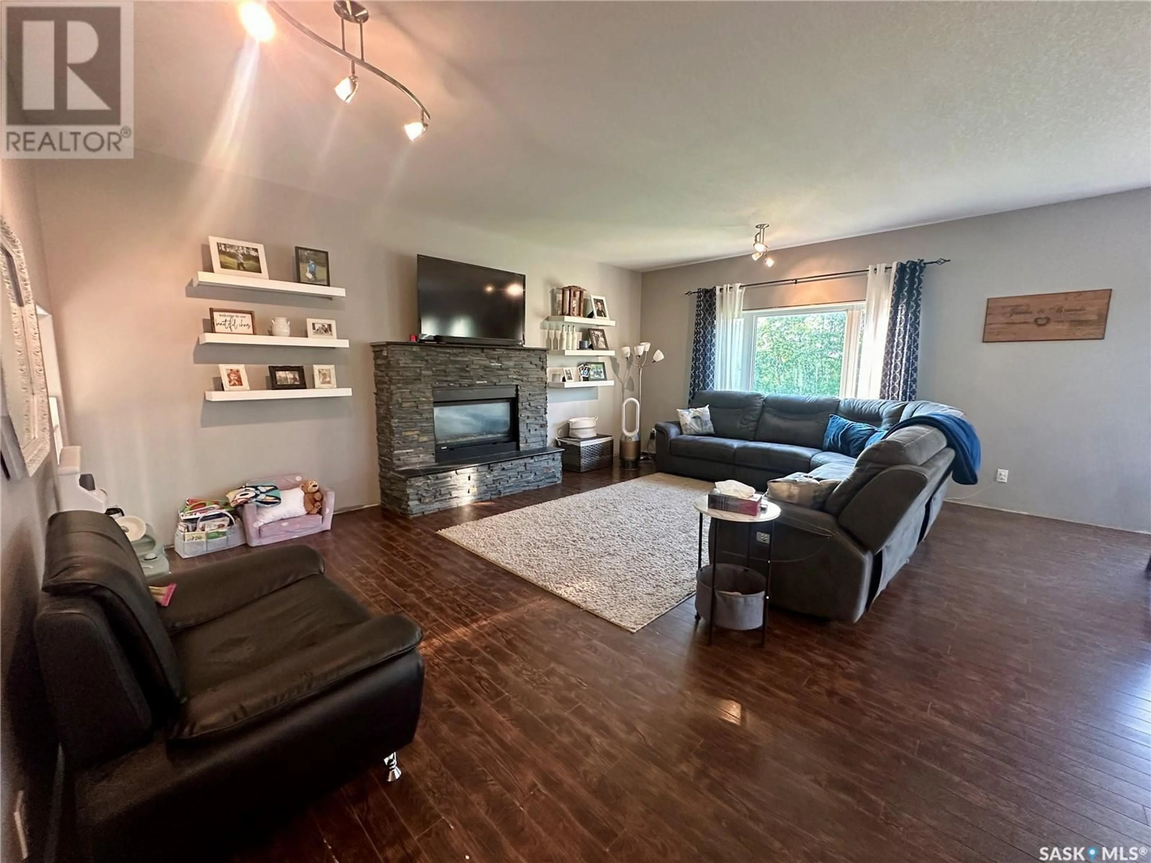 Living room with furniture, wood/laminate floor for 205 ROBERTS AVENUE, Canora Saskatchewan S0A0L0