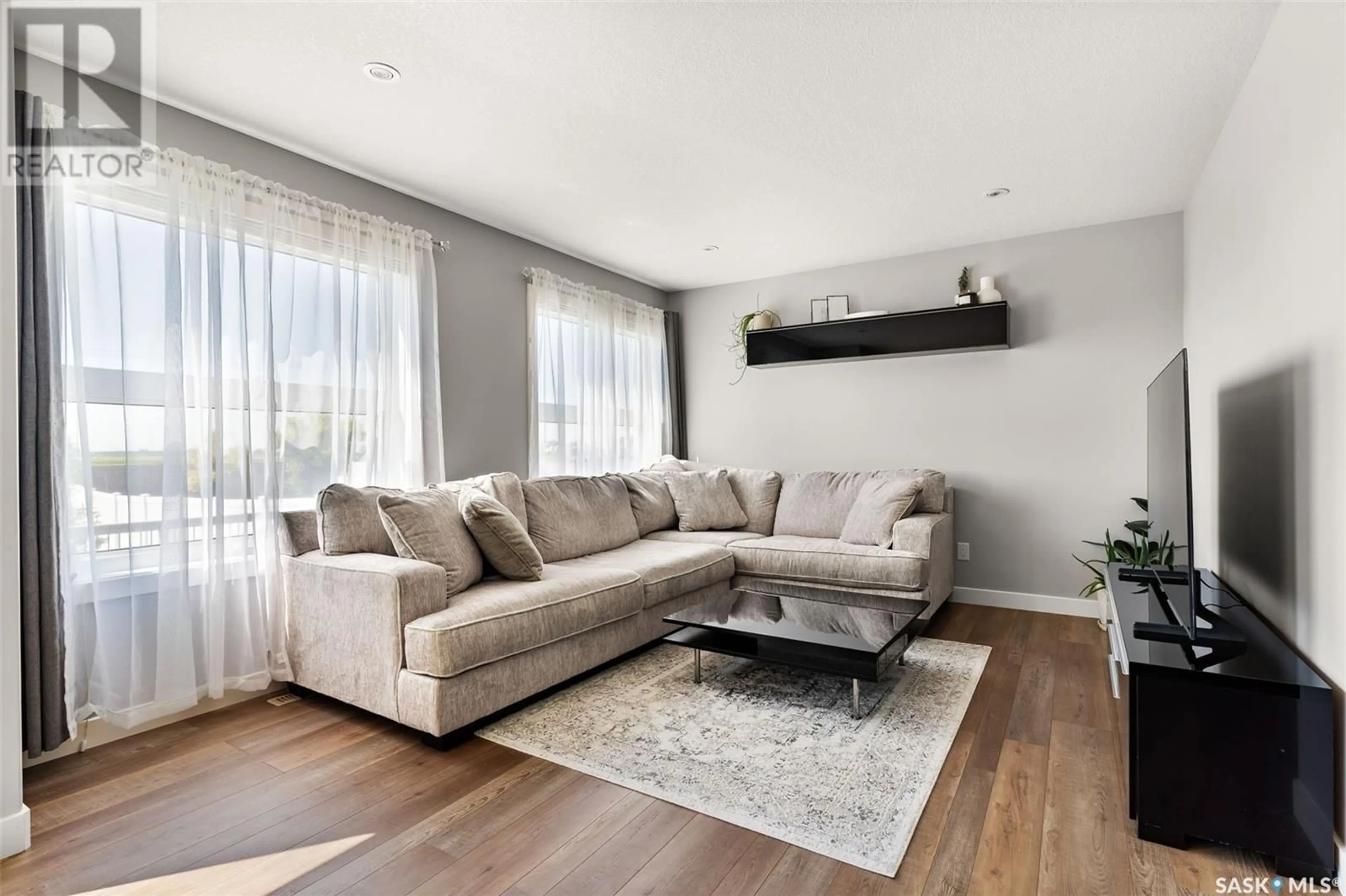Living room with furniture, wood/laminate floor for 5220 CRANE CRESCENT, Regina Saskatchewan S4W0J3