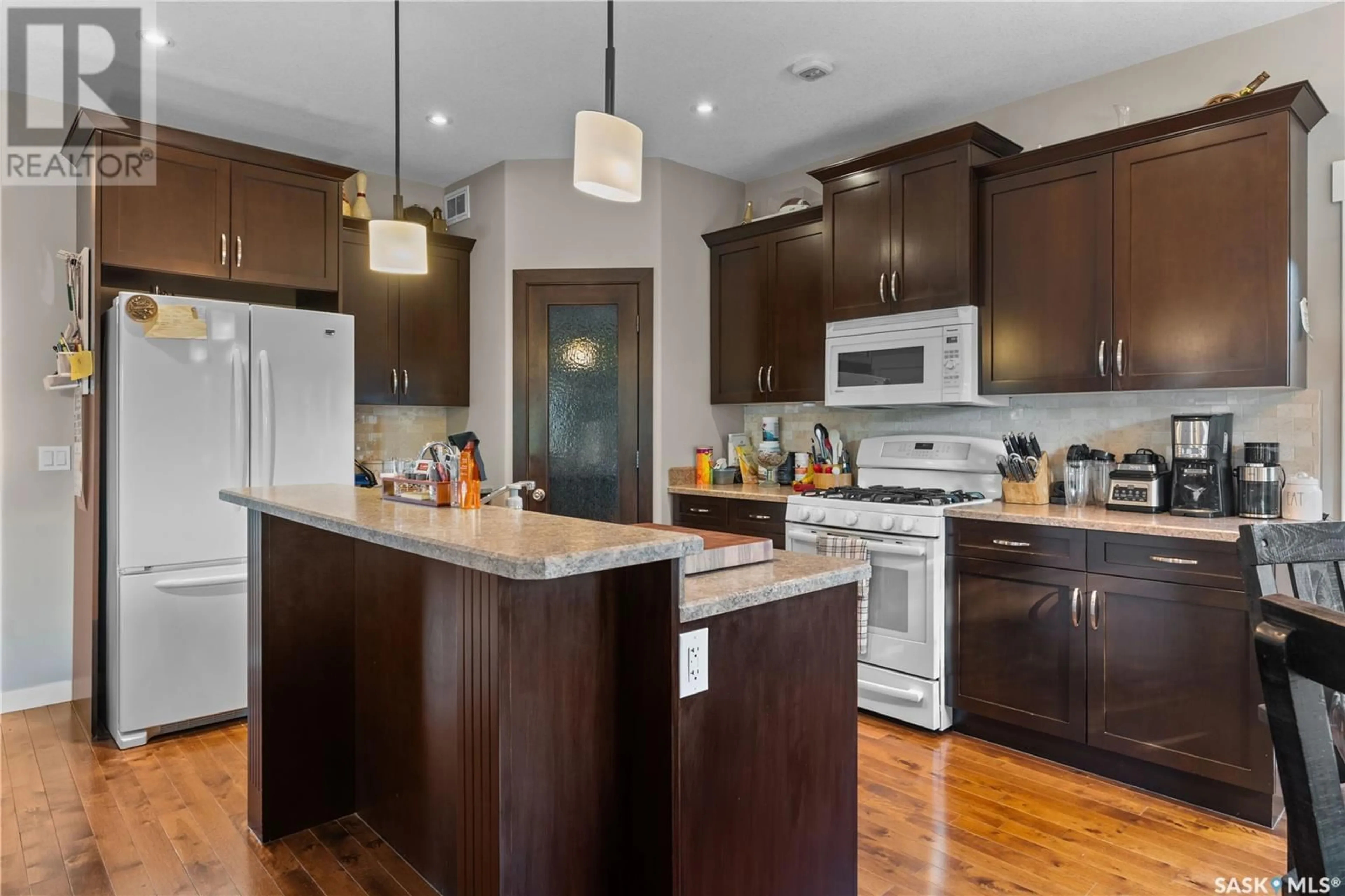 Open concept kitchen, wood/laminate floor for 4 NADIA BAY, Pense Saskatchewan S0G3W0