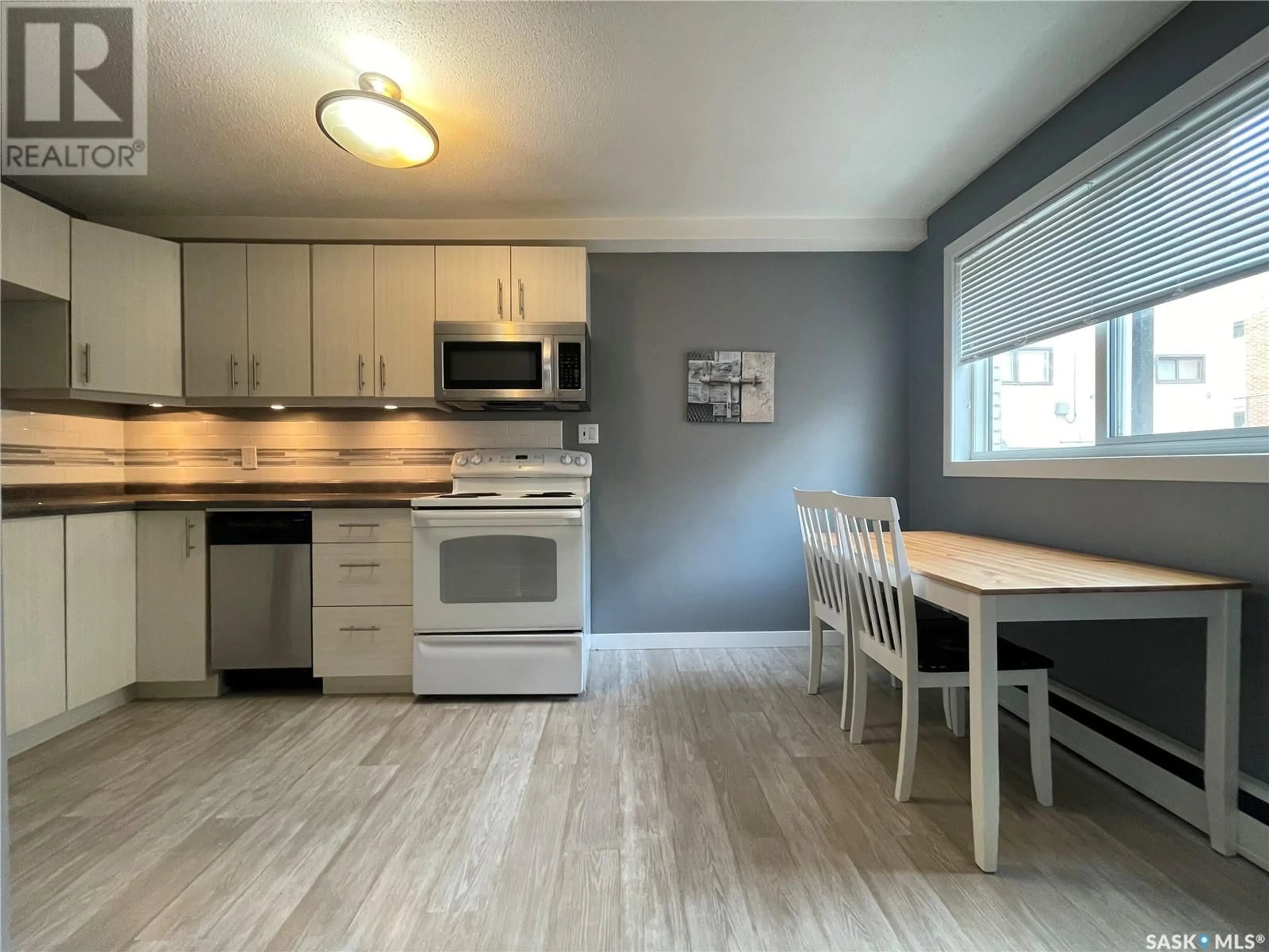 Open concept kitchen, wood/laminate floor for 6 2157 RAE STREET, Regina Saskatchewan S4T2E8