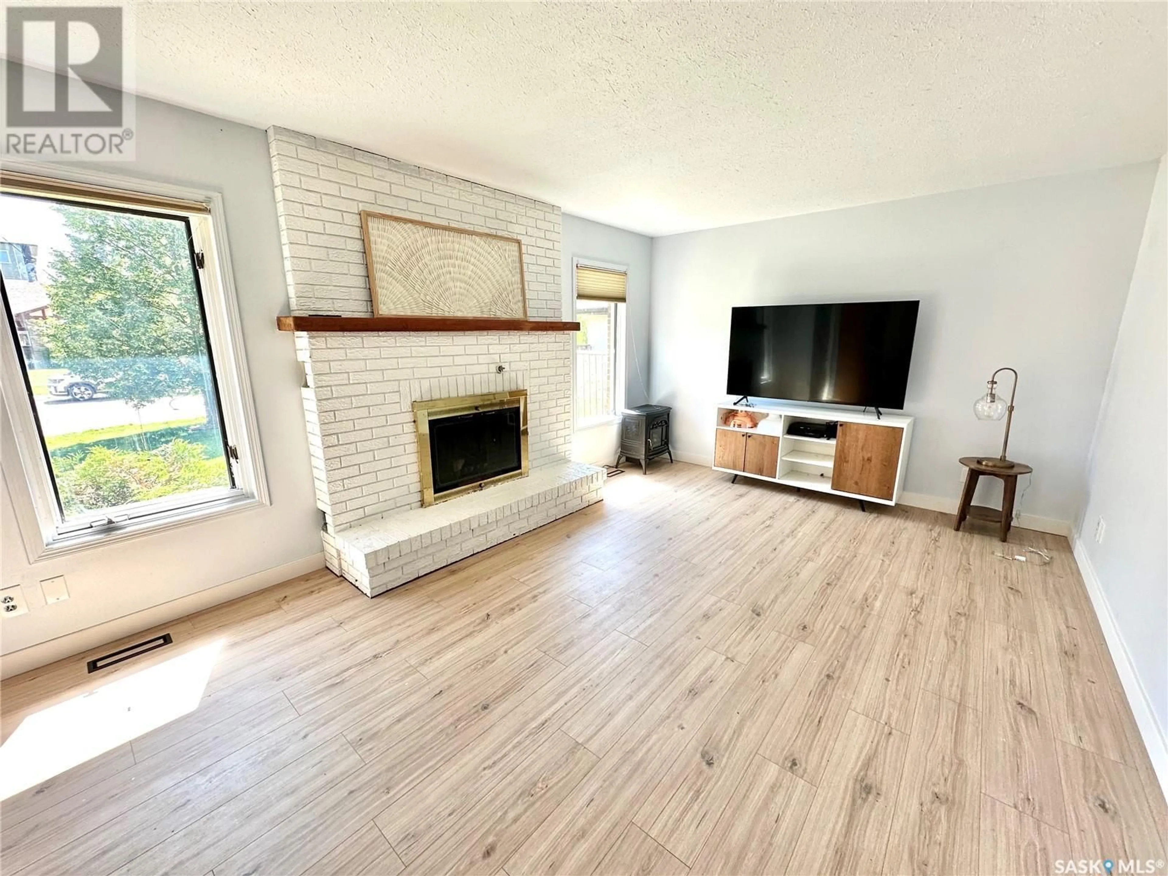 Living room with furniture, wood/laminate floor for 2503 CARDINAL CRESCENT, North Battleford Saskatchewan S9A3X2