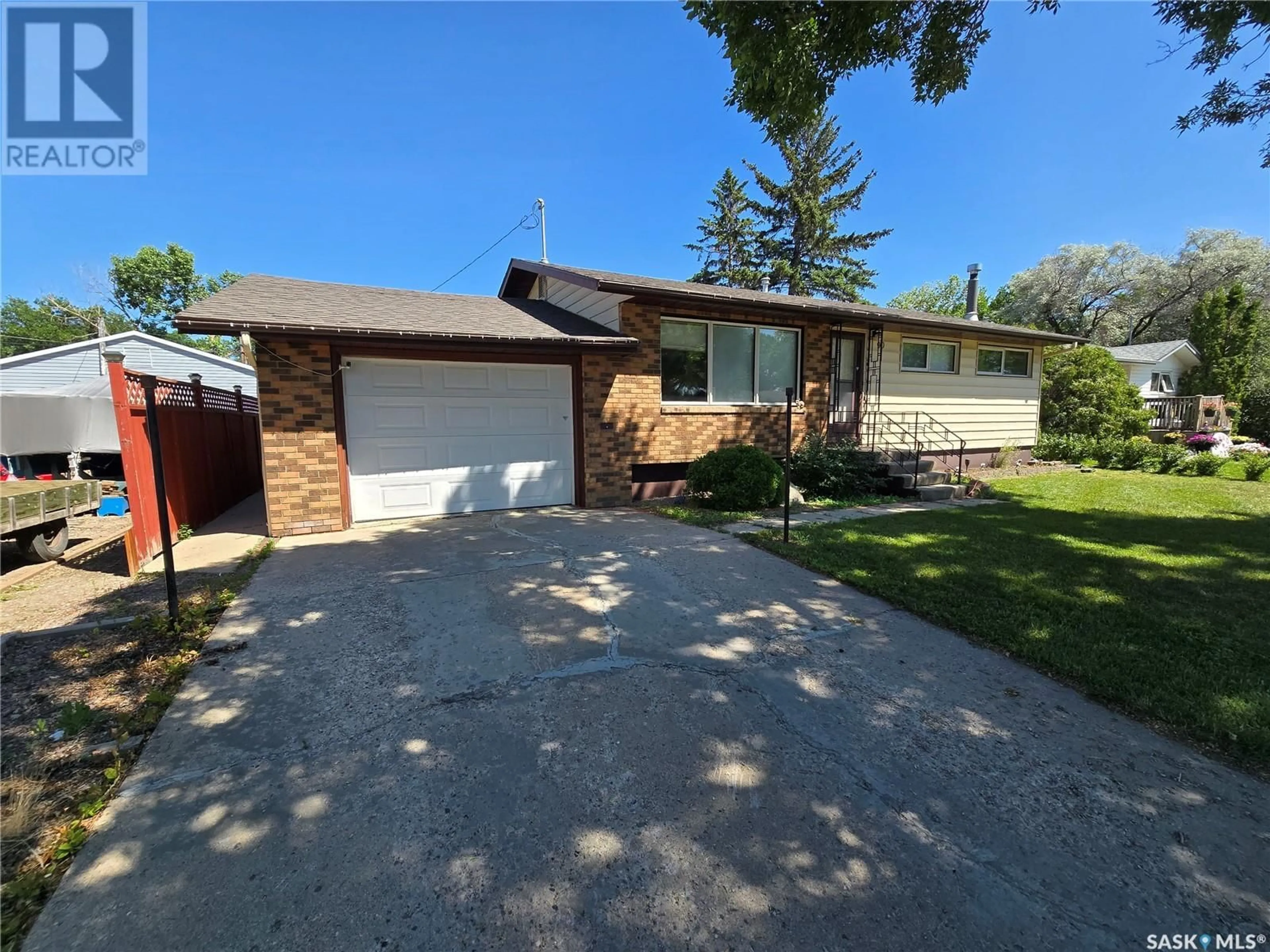 A pic from outside/outdoor area/front of a property/back of a property/a pic from drone, street for 90 12TH STREET, Weyburn Saskatchewan S4H1K5