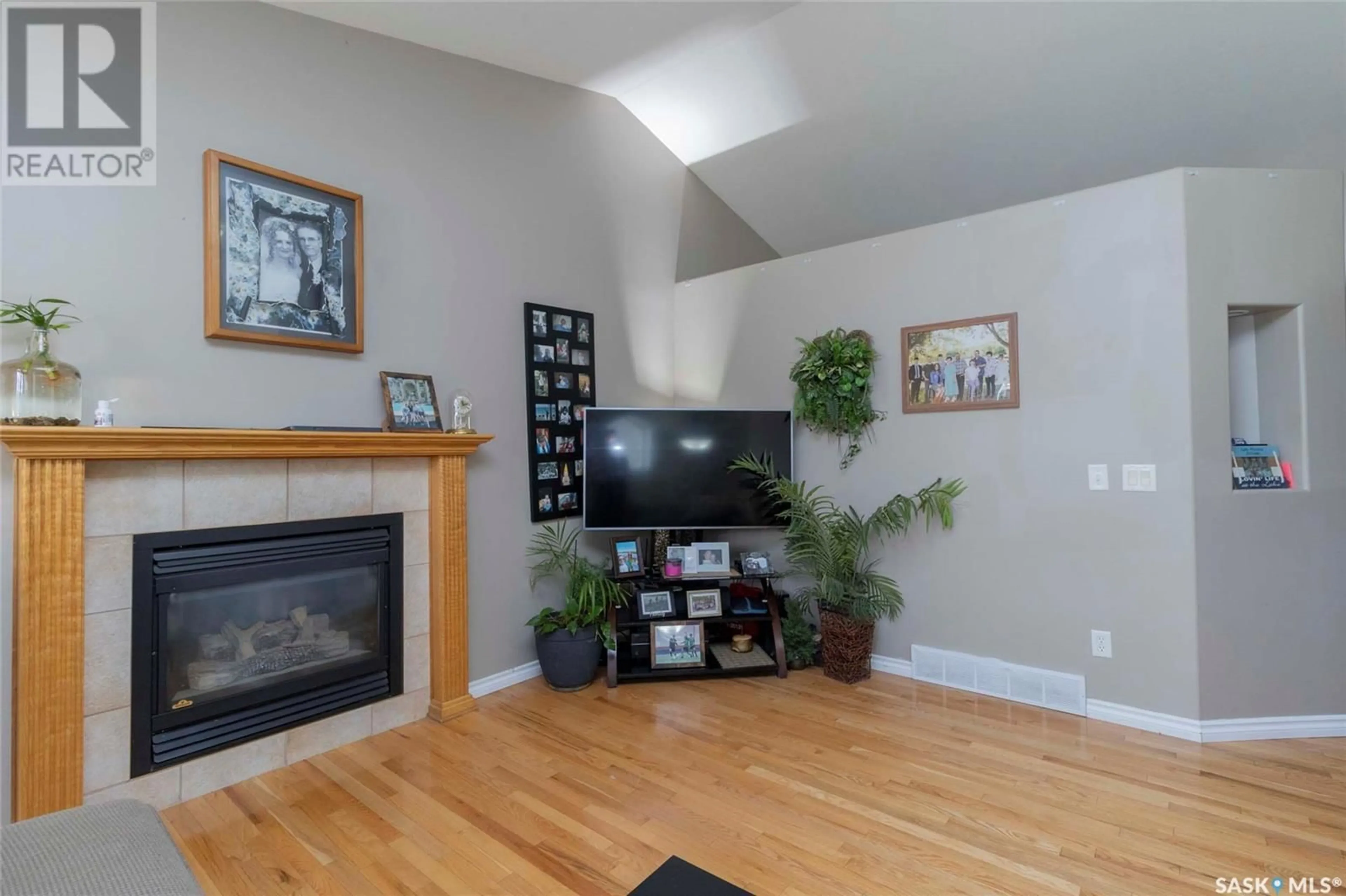 Living room with furniture, wood/laminate floor for 701 SLATER CRESCENT, Martensville Saskatchewan S0K2T0