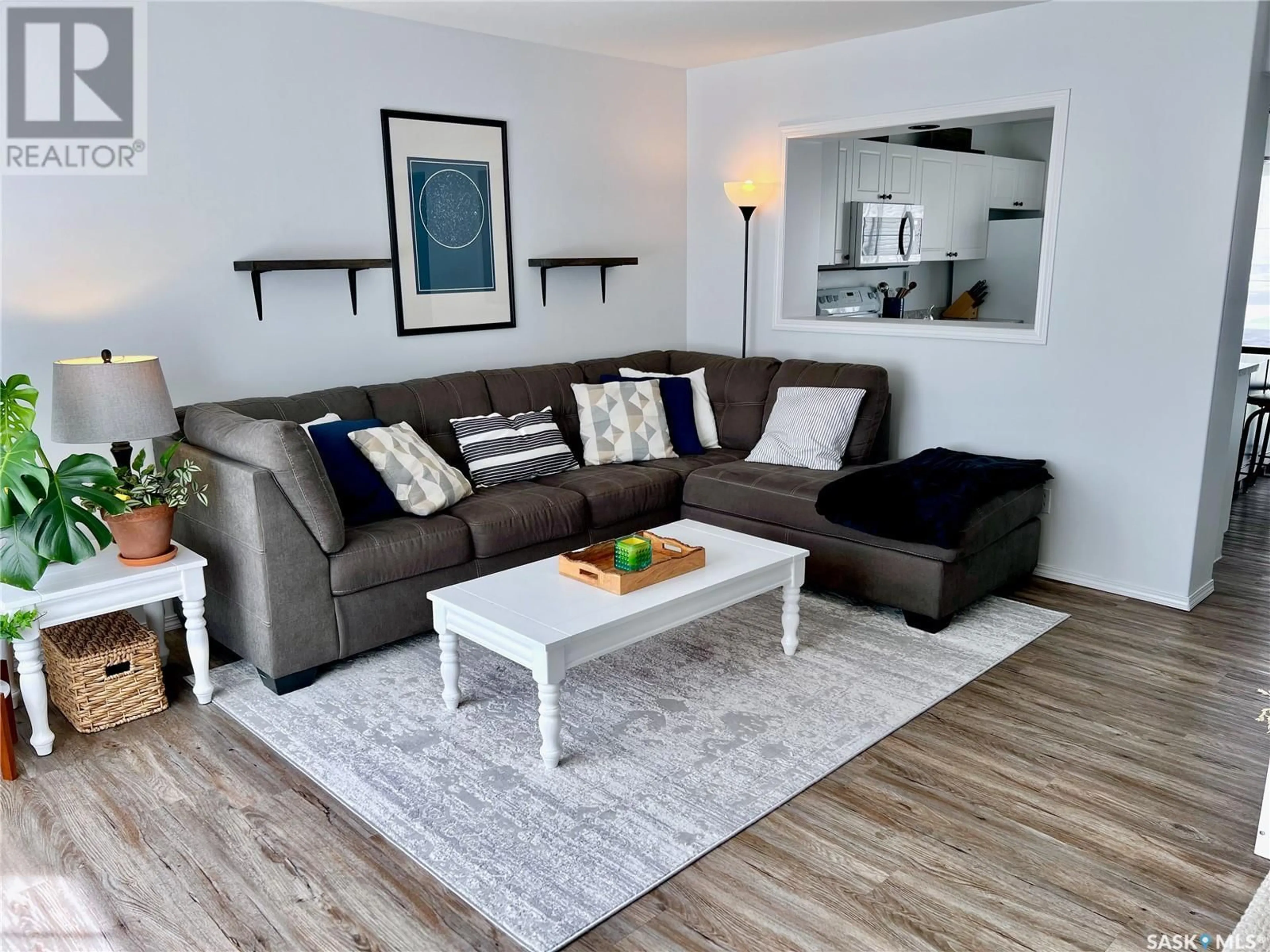Living room with furniture, wood/laminate floor for 670 - 241 KENDERDINE ROAD, Saskatoon Saskatchewan S7N4W5