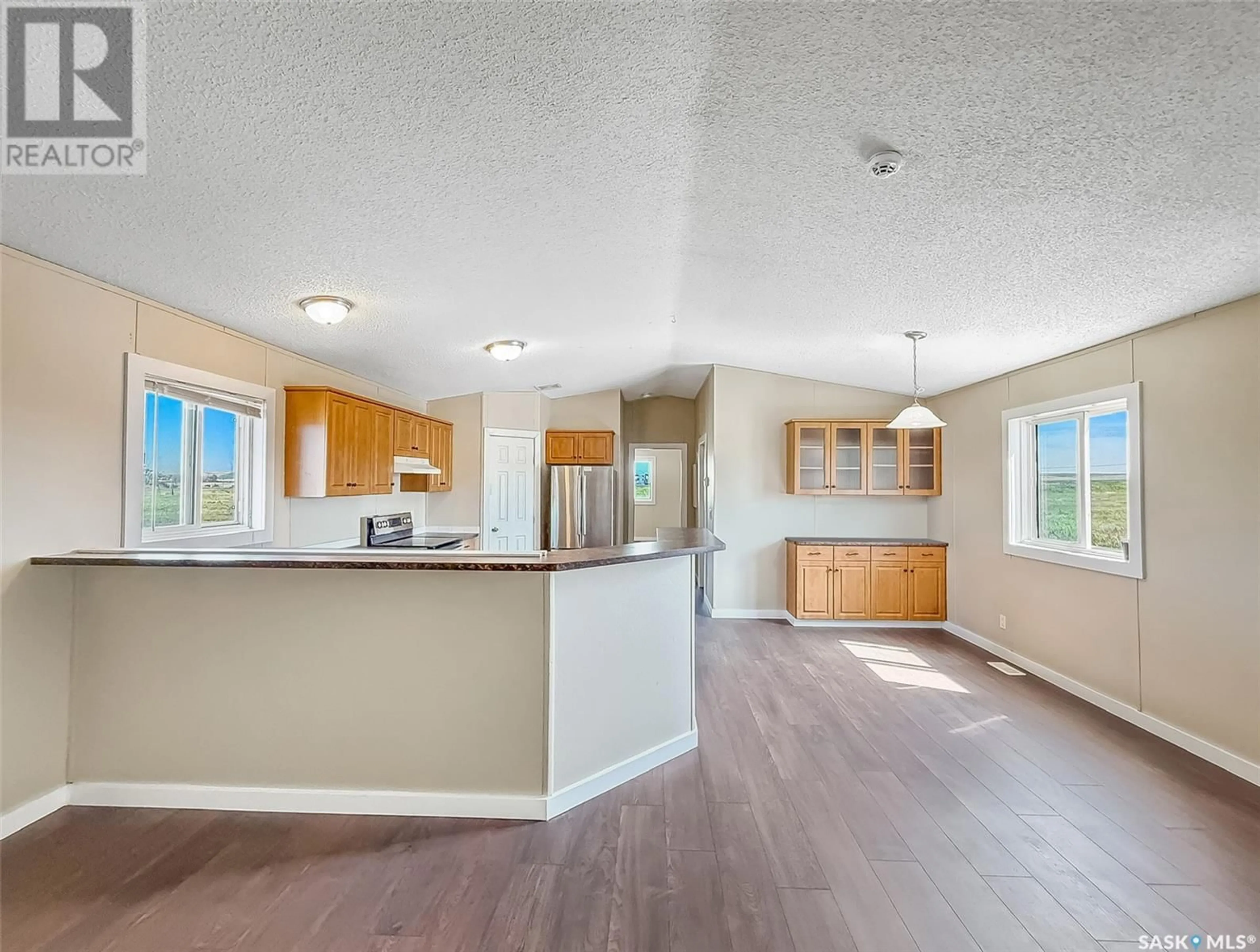 Open concept kitchen, wood/laminate floor for 129 BELLA DRIVE, Swift Current Saskatchewan S9H5T6