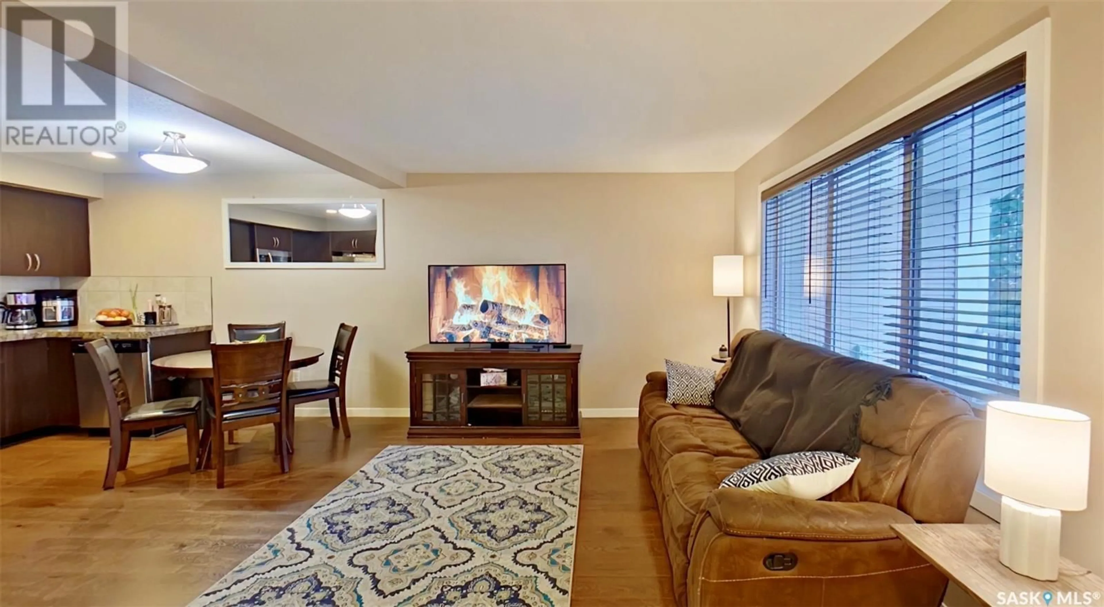 Living room with furniture, wood/laminate floor for 4541 - 12 DELHAYE WAY, Regina Saskatchewan S4W0M2