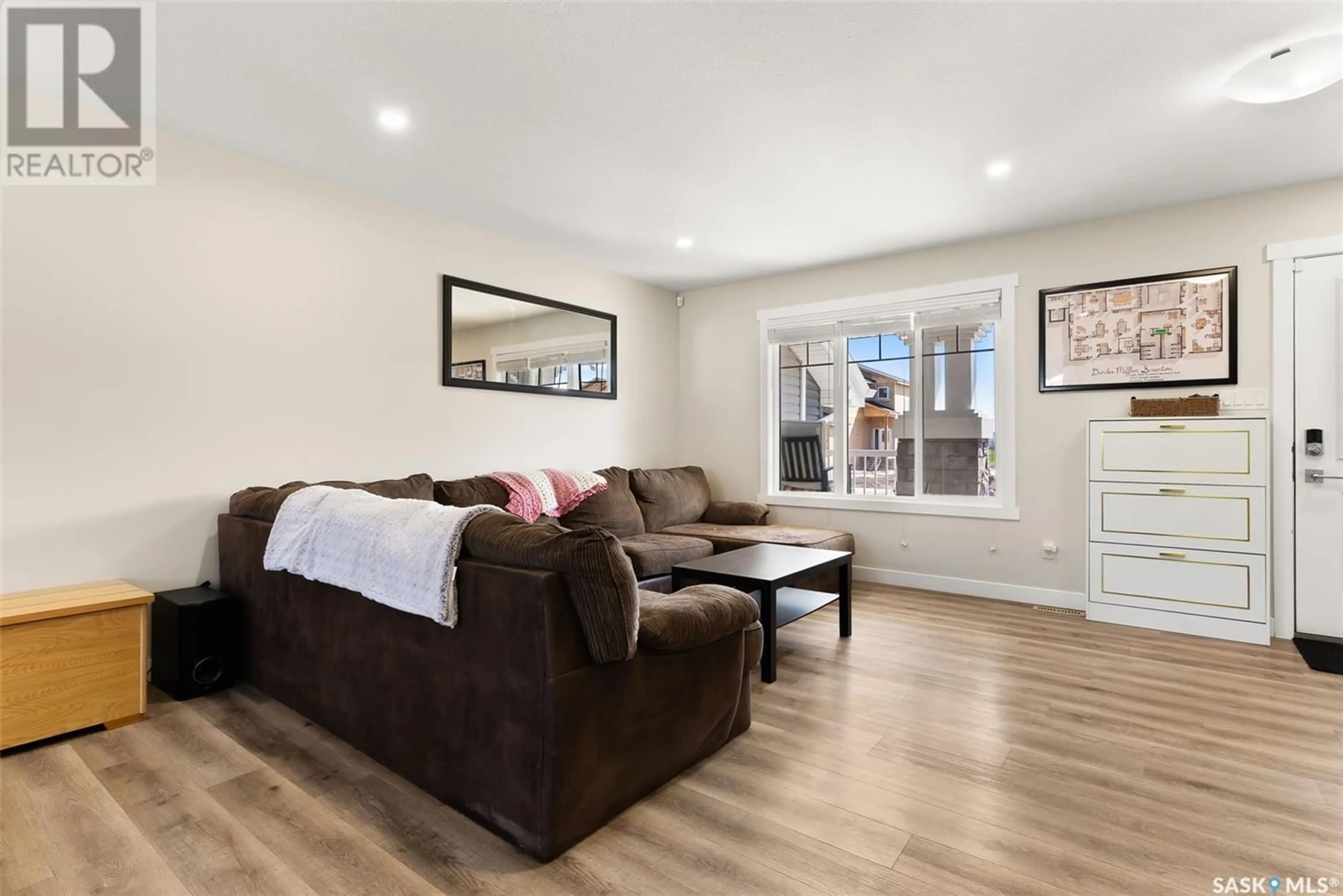 Living room with furniture, wood/laminate floor for 3150 GREEN STONE ROAD, Regina Saskatchewan S4V3R8