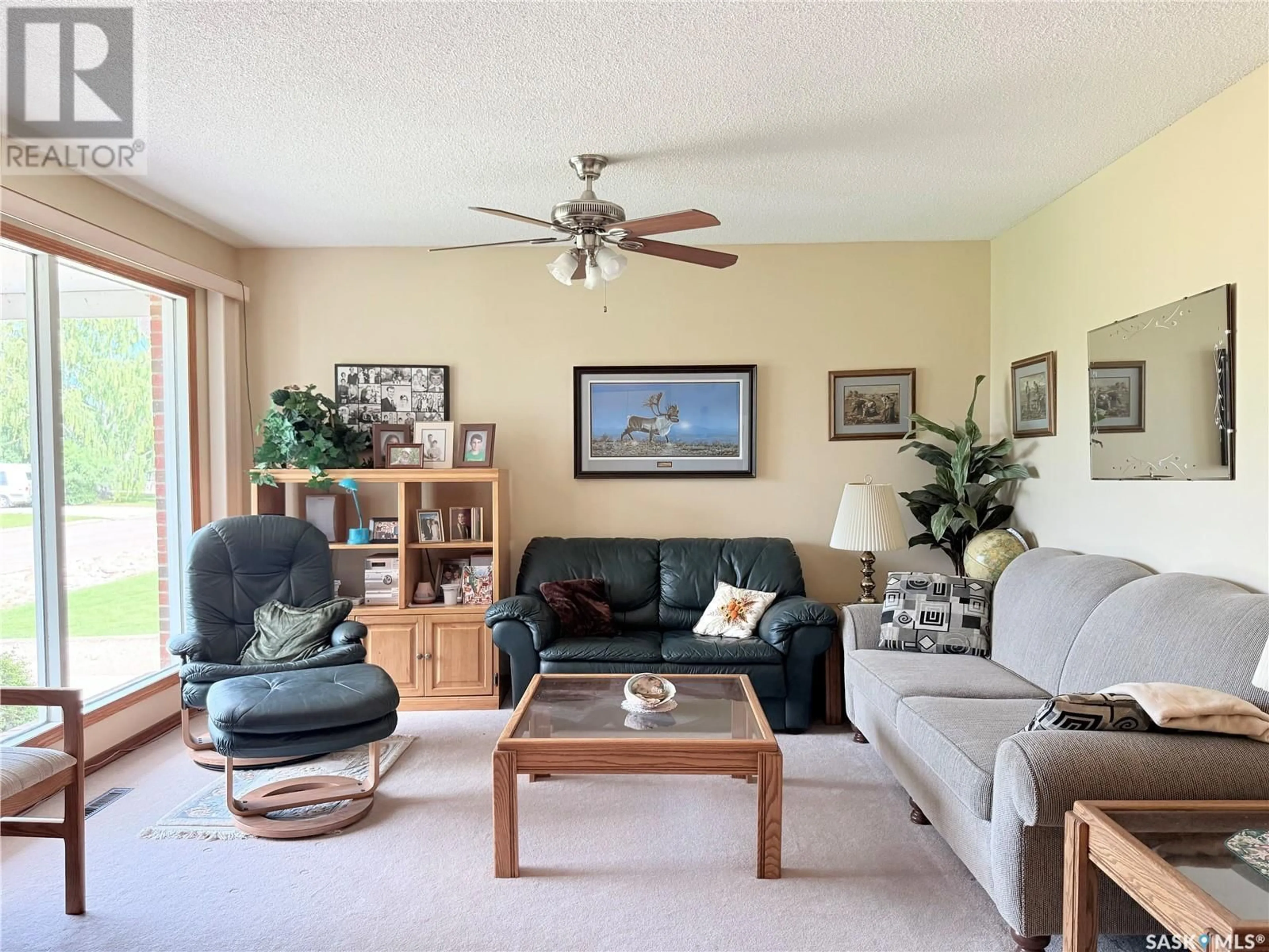 Living room with furniture, wood/laminate floor for 51 TUFTS CRESCENT, Outlook Saskatchewan S0L2N0