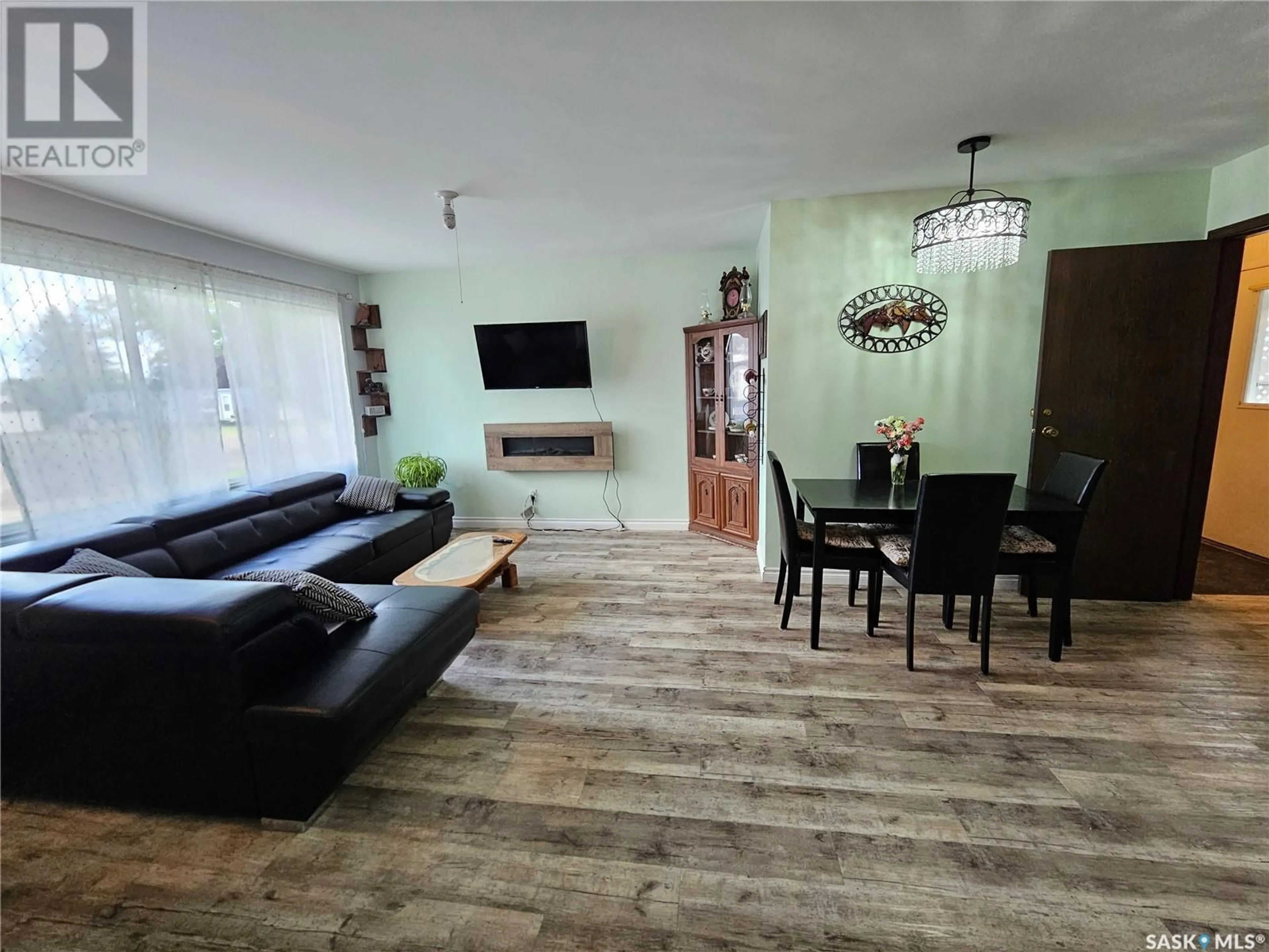 Living room with furniture, wood/laminate floor for 113 1ST STREET, Goodsoil Saskatchewan S0M1A0
