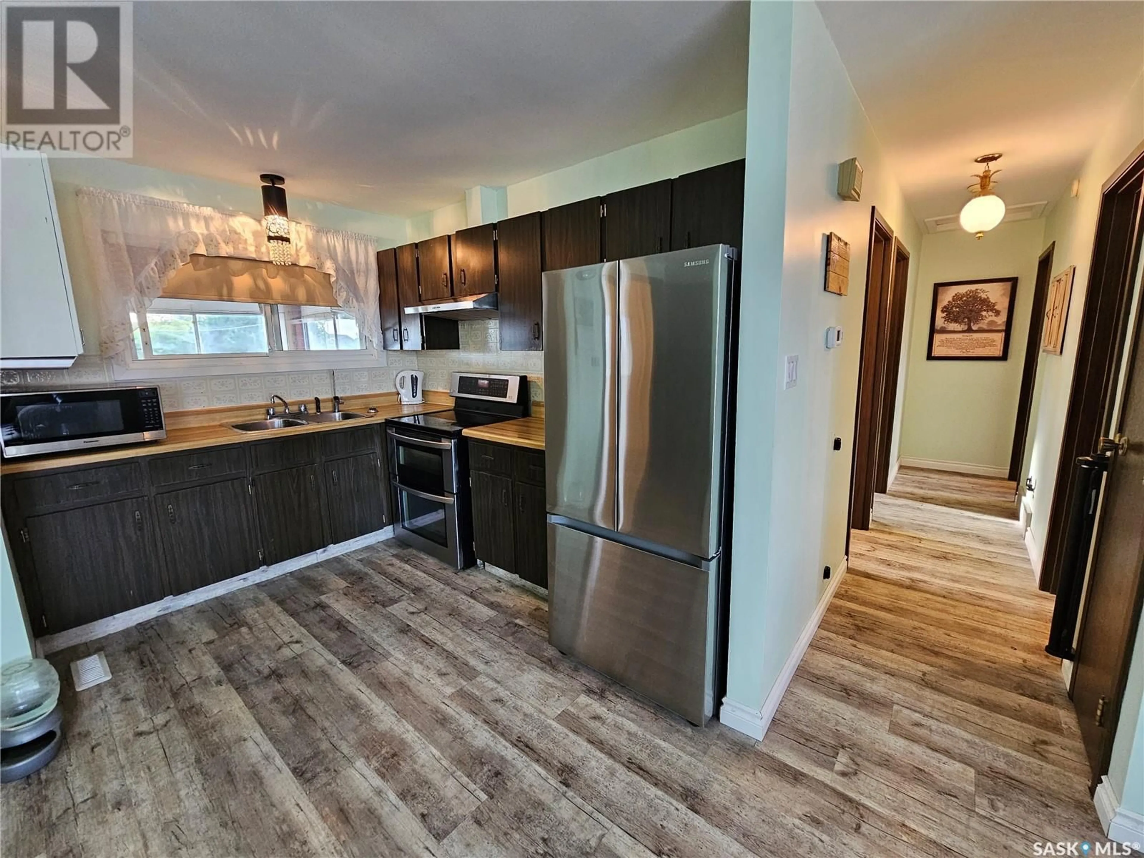 Open concept kitchen, wood/laminate floor for 113 1ST STREET, Goodsoil Saskatchewan S0M1A0