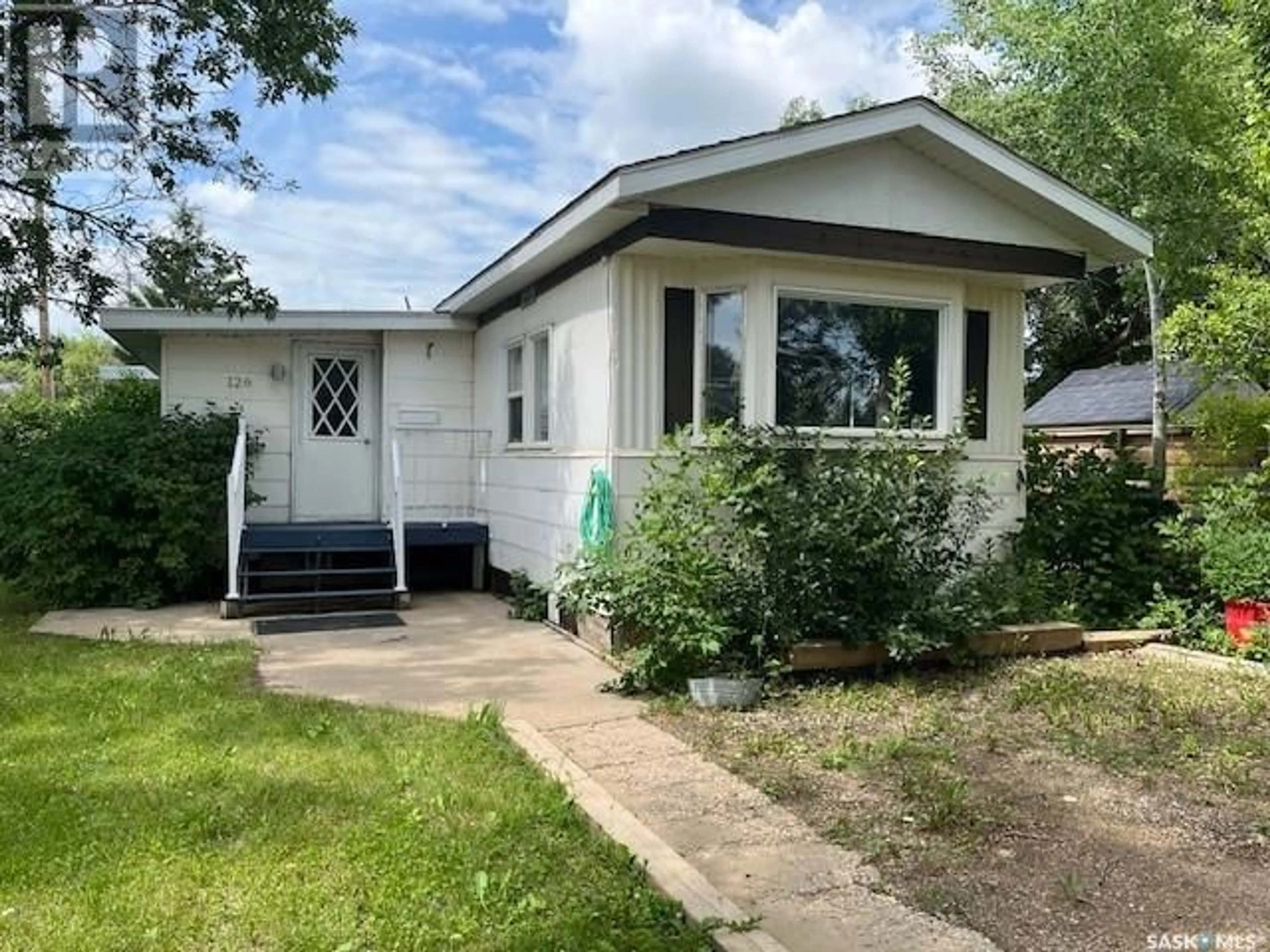 Home with vinyl exterior material, street for 126 DOGWOOD STREET, Caronport Saskatchewan S0H0S0