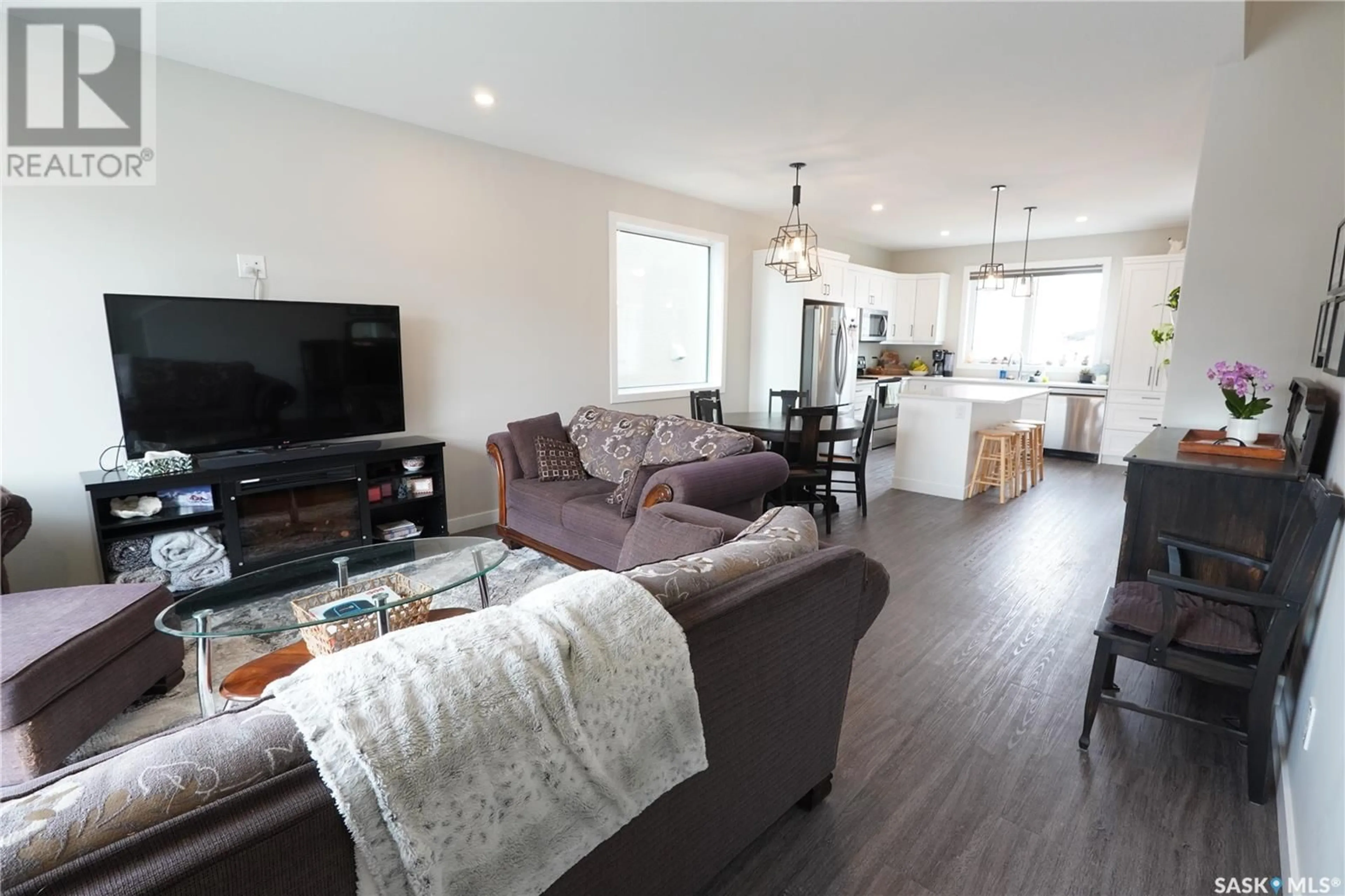 Living room with furniture, wood/laminate floor for 3240 GREEN WATER DRIVE, Regina Saskatchewan S4V3R5