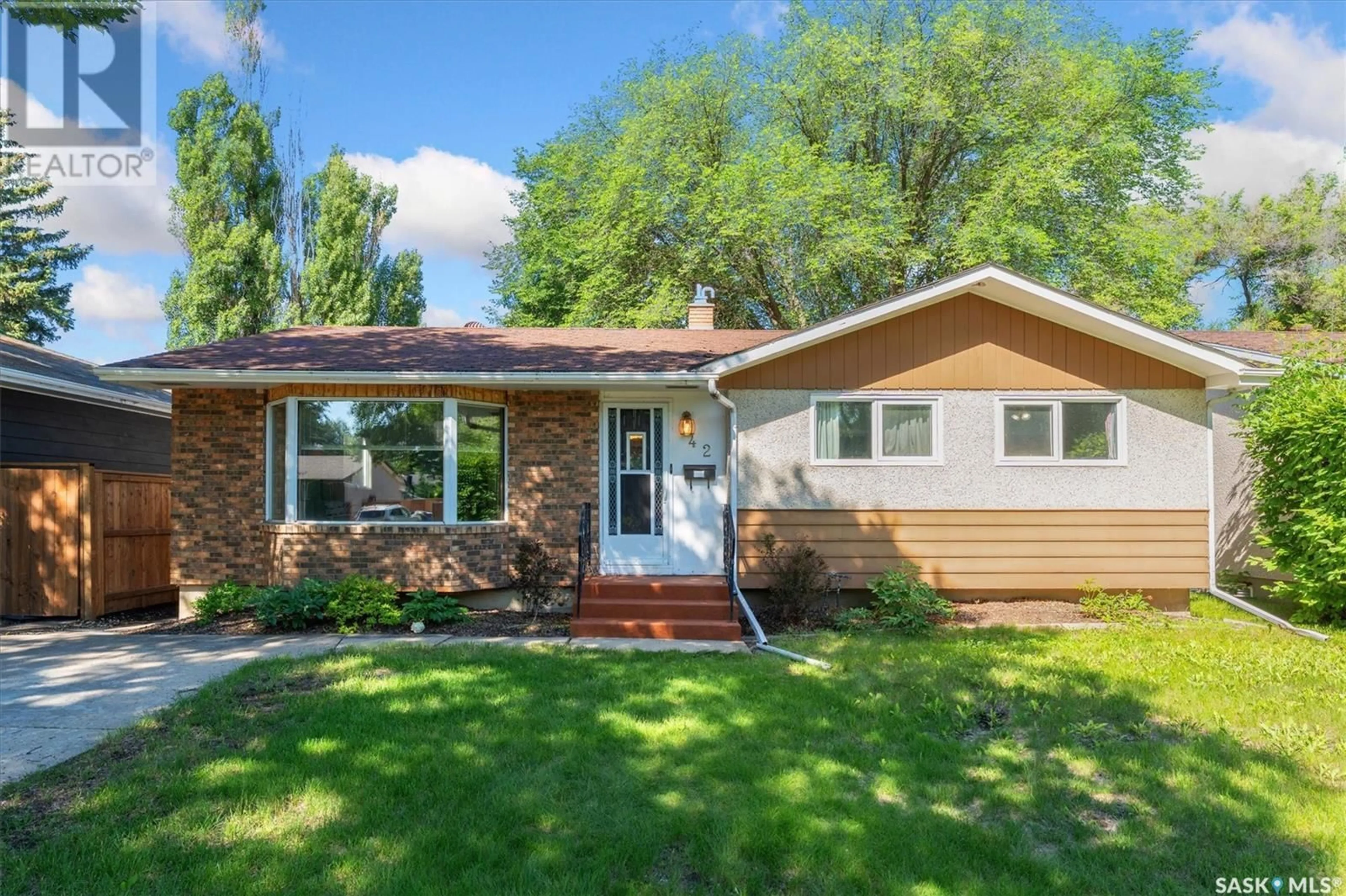 Home with vinyl exterior material, street for 42 MCLELLAN AVENUE, Saskatoon Saskatchewan S7H3K6