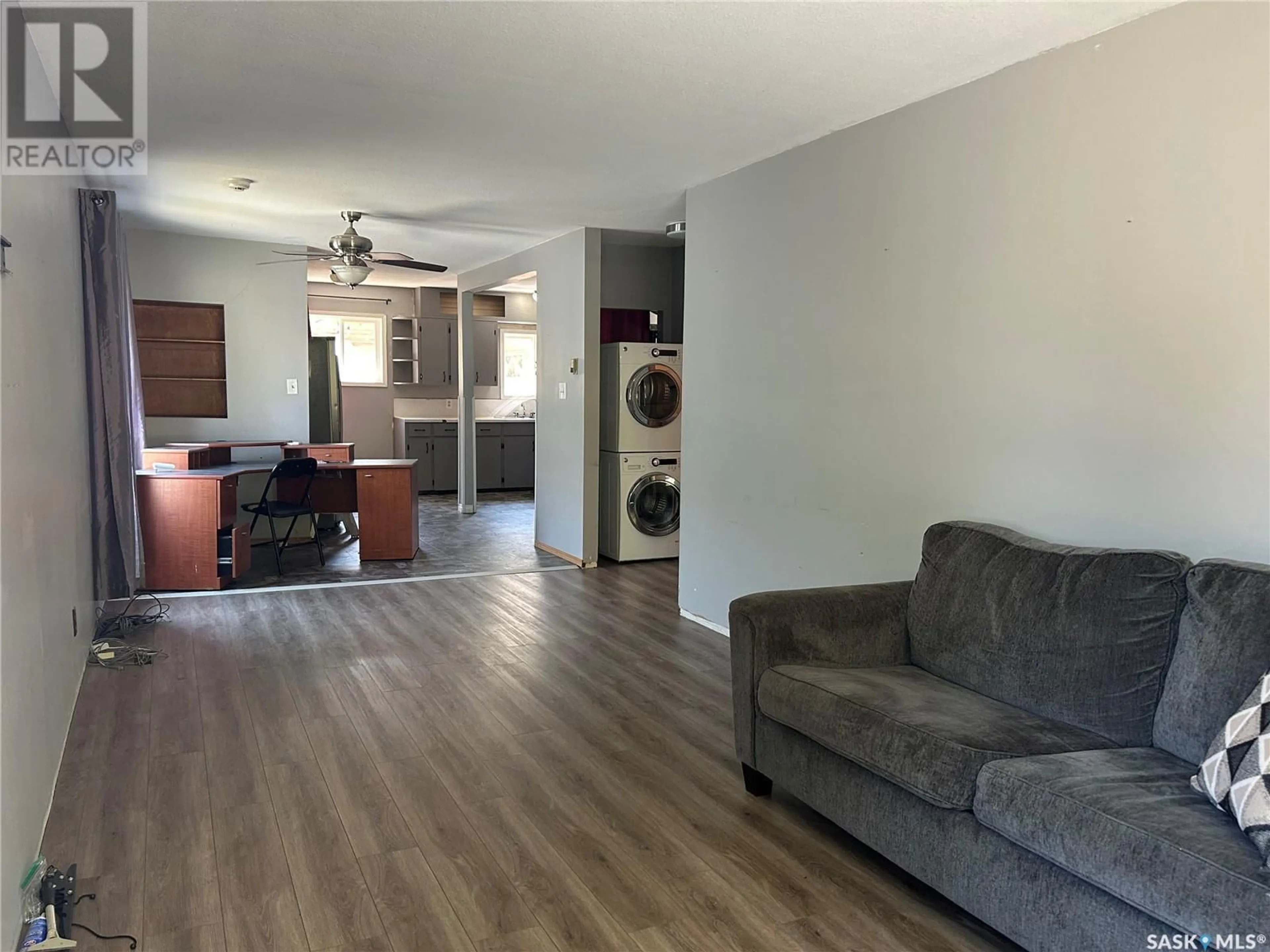 Living room with furniture, wood/laminate floor for 523 OMINICA STREET, Moose Jaw Saskatchewan S6H0H2