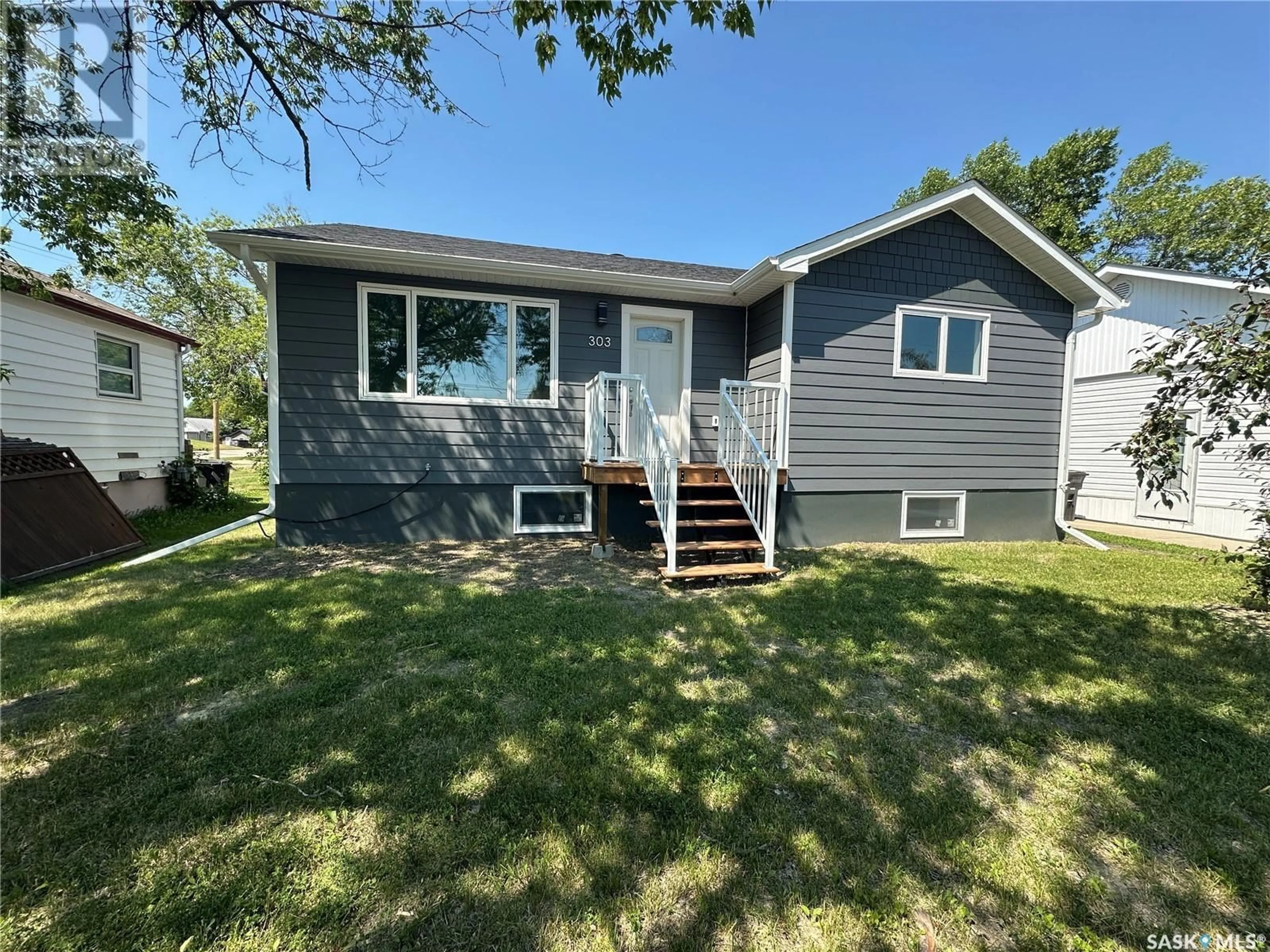 Home with vinyl exterior material, street for 303 2ND STREET, Watson Saskatchewan S0K4V0