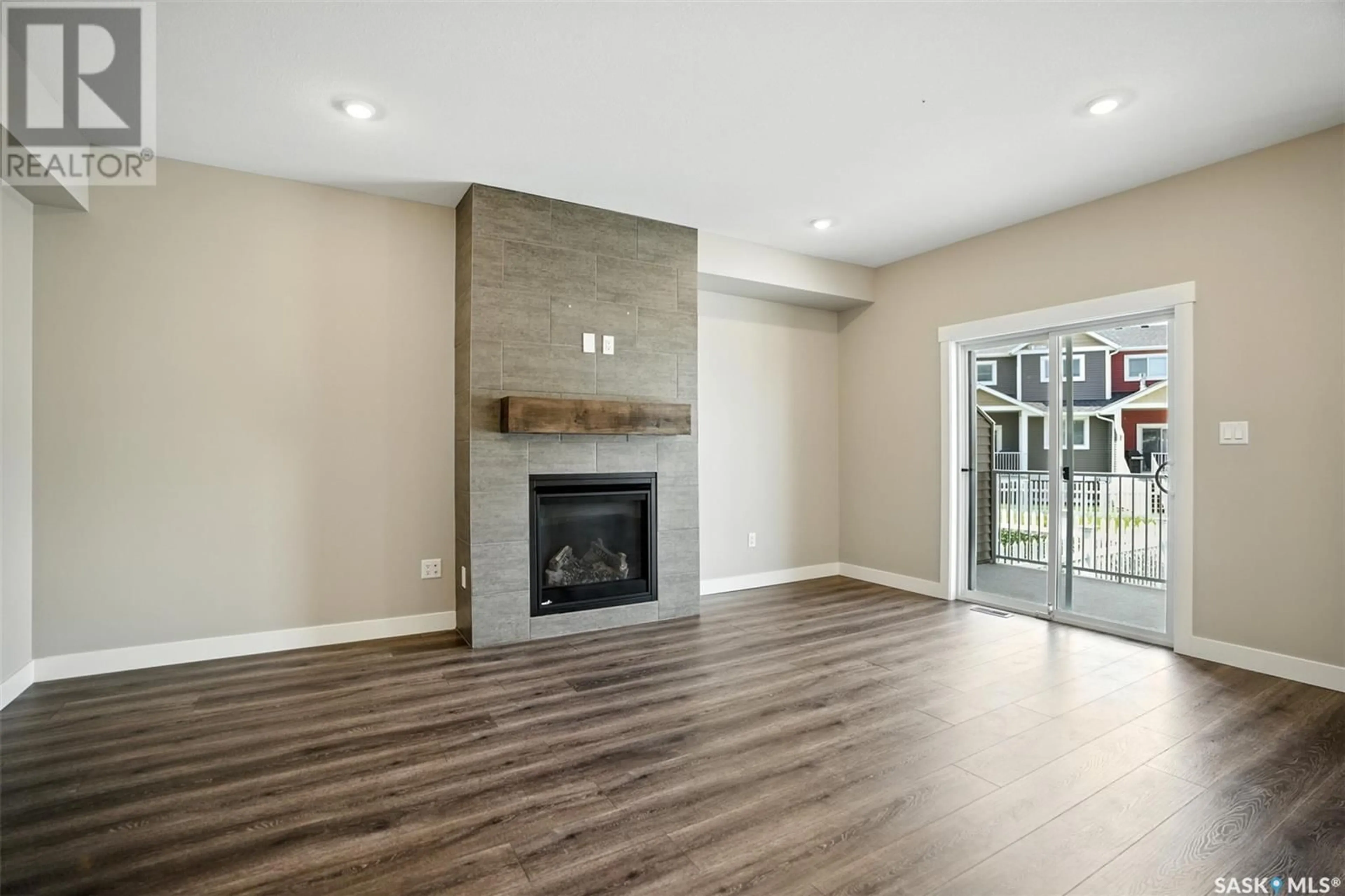 Living room with furniture, wood/laminate floor for 21 900 ST ANDREWS LANE, Warman Saskatchewan S0K4S4