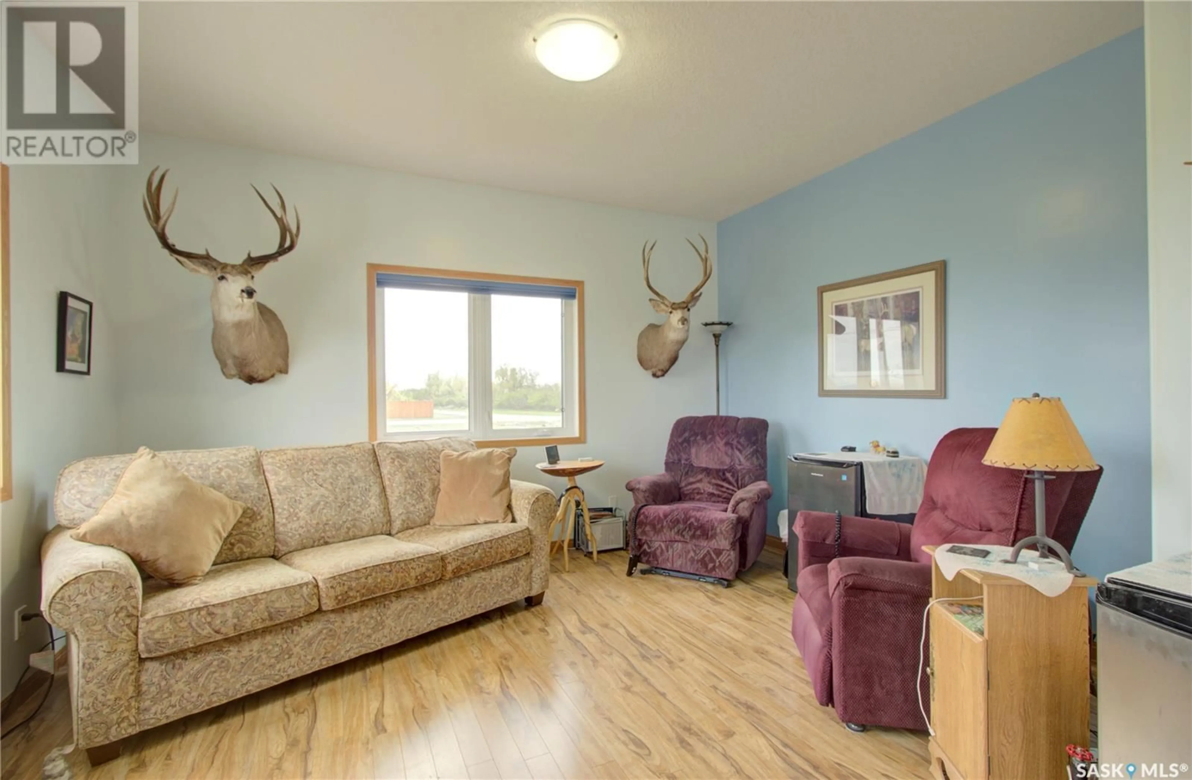 Living room with furniture, wood/laminate floor for 91 1ST STREET, Coteau Rm No. 255 Saskatchewan S0L0G0