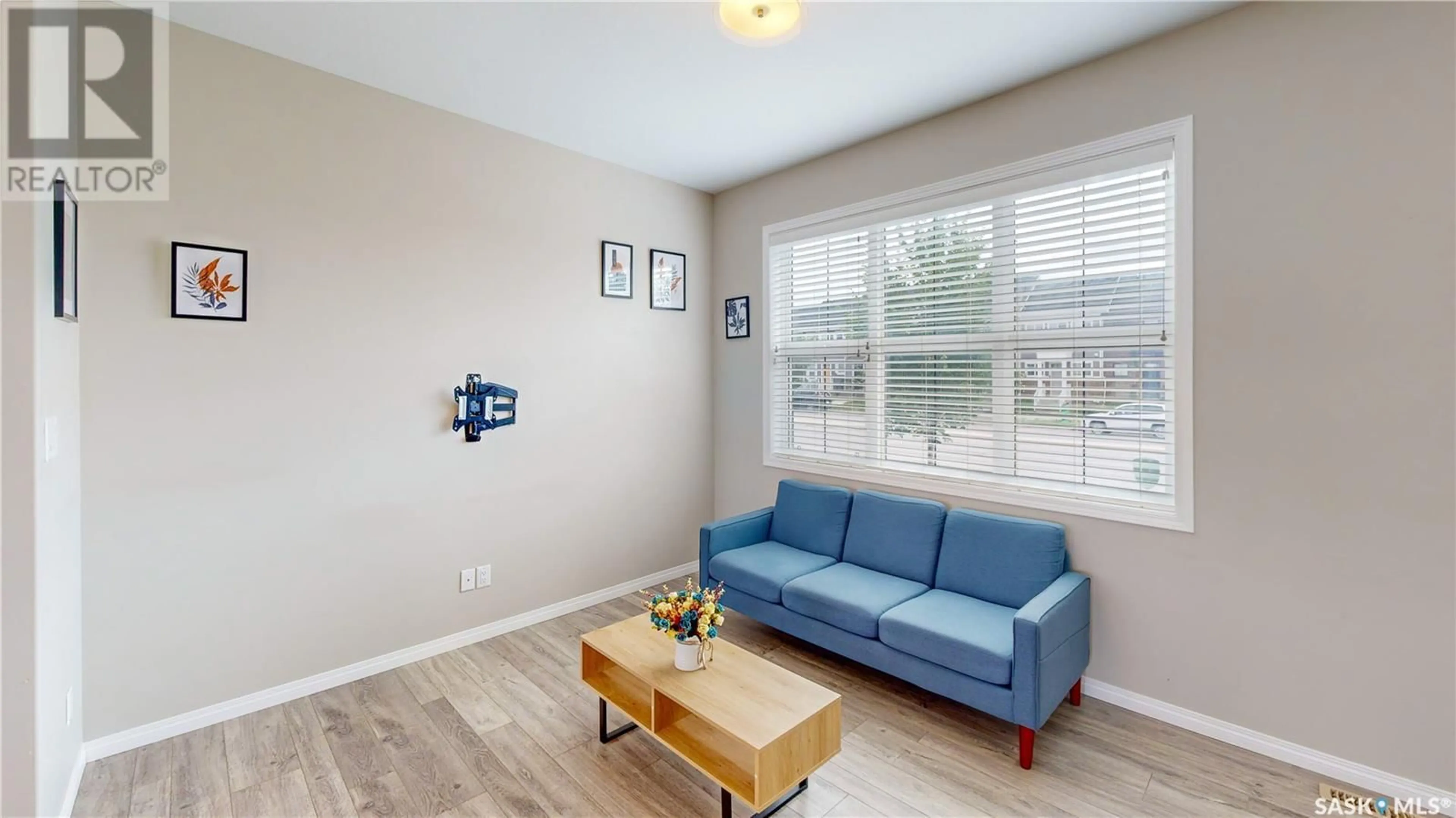 Living room with furniture, wood/laminate floor for 3294 CHUKA BOULEVARD, Regina Saskatchewan S4V3S6