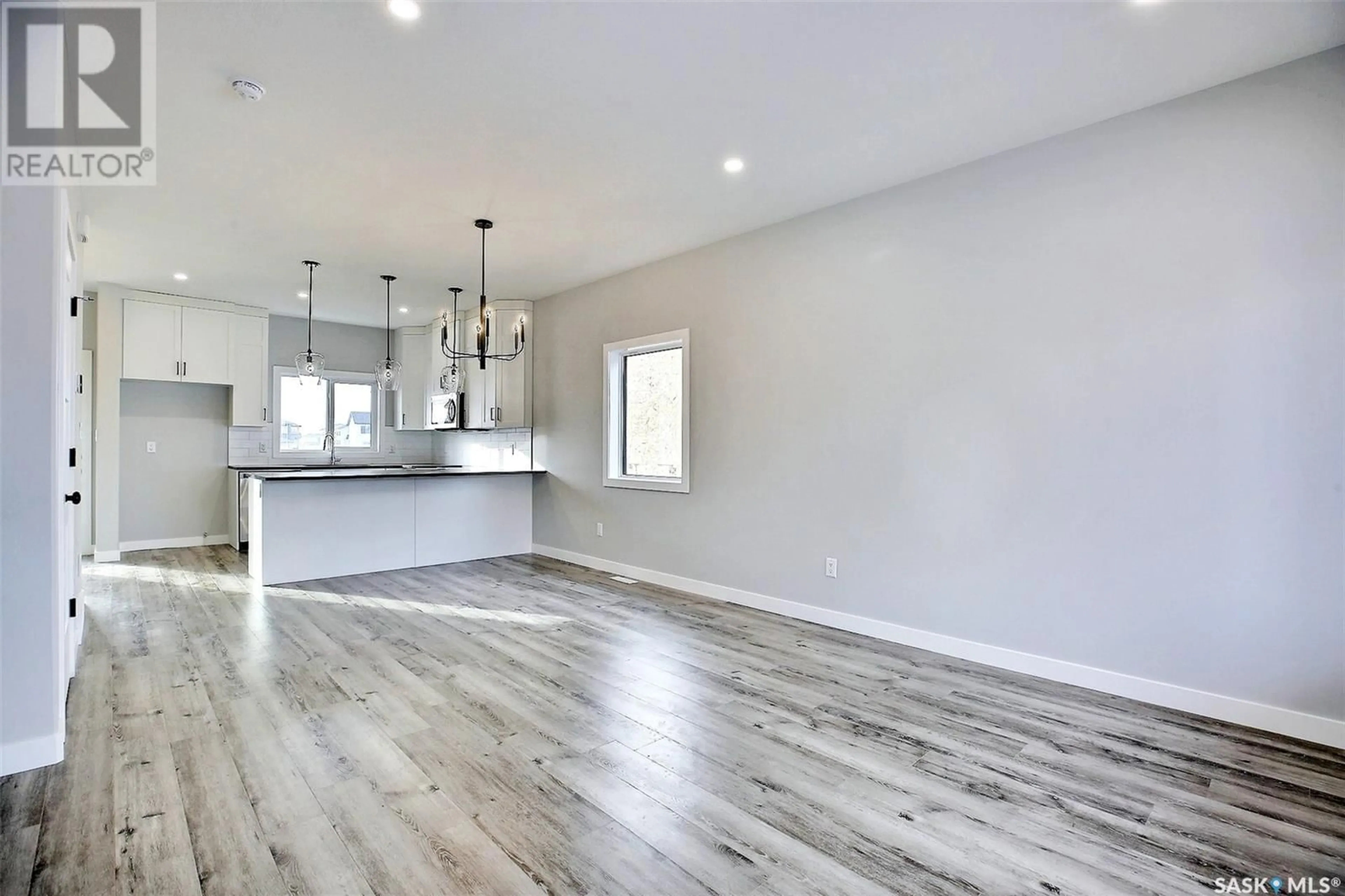 Open concept kitchen, wood/laminate floor for 3140 GREEN TURTLE ROAD, Regina Saskatchewan S4N7K9