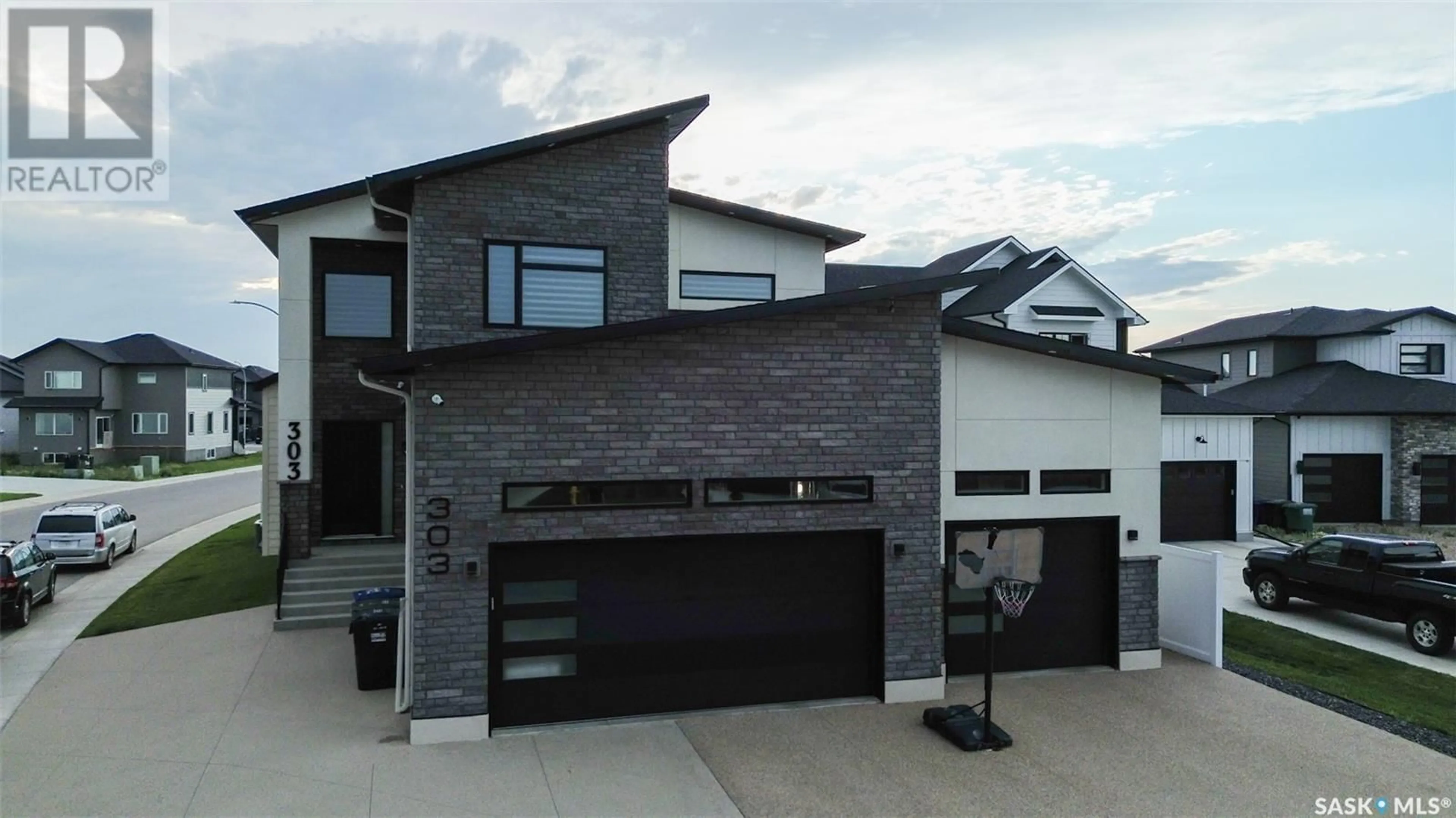 Home with brick exterior material, street for 303 WOOLF BAY, Saskatoon Saskatchewan S7W1E5