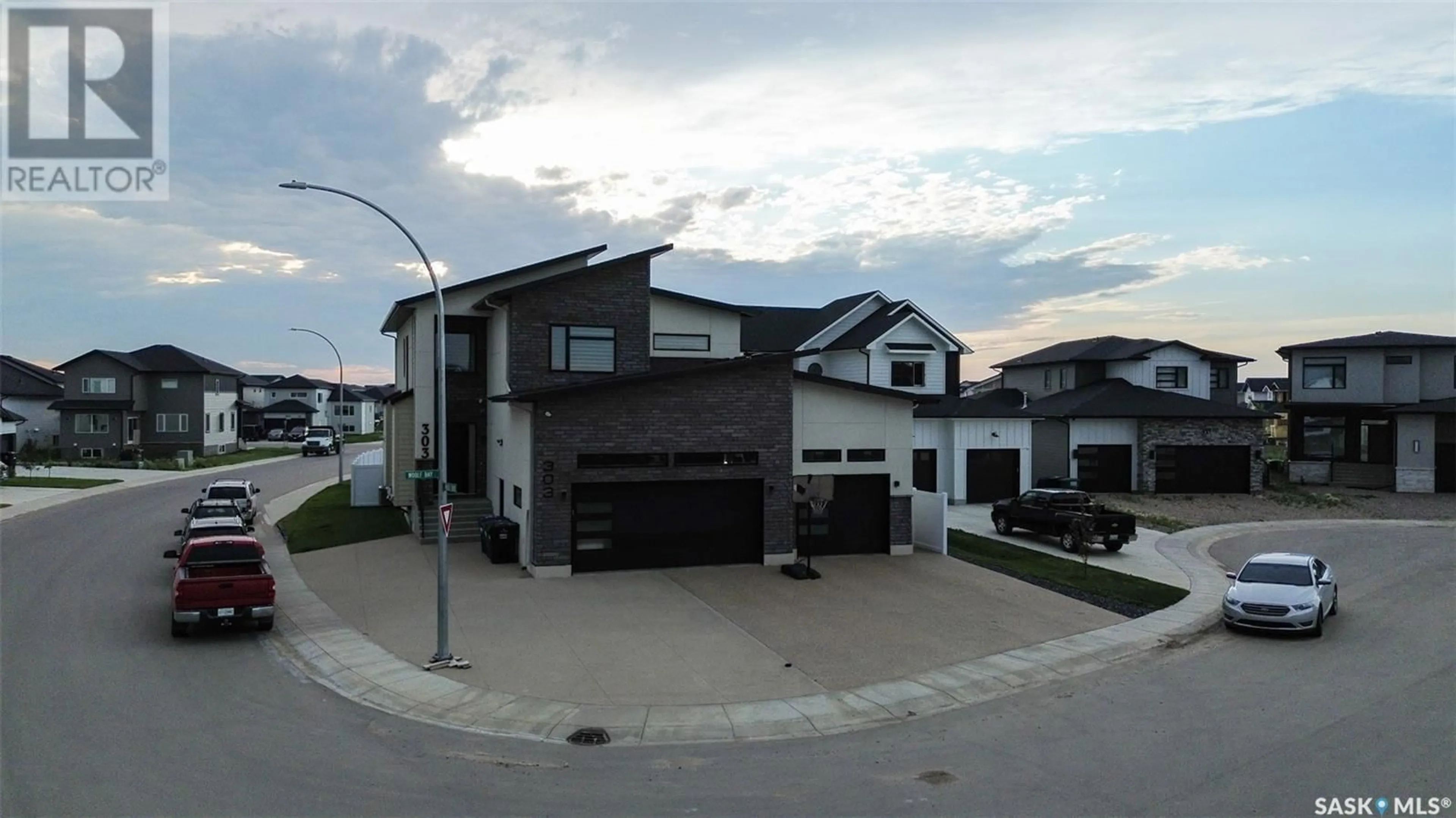 A pic from outside/outdoor area/front of a property/back of a property/a pic from drone, street for 303 WOOLF BAY, Saskatoon Saskatchewan S7W1E5