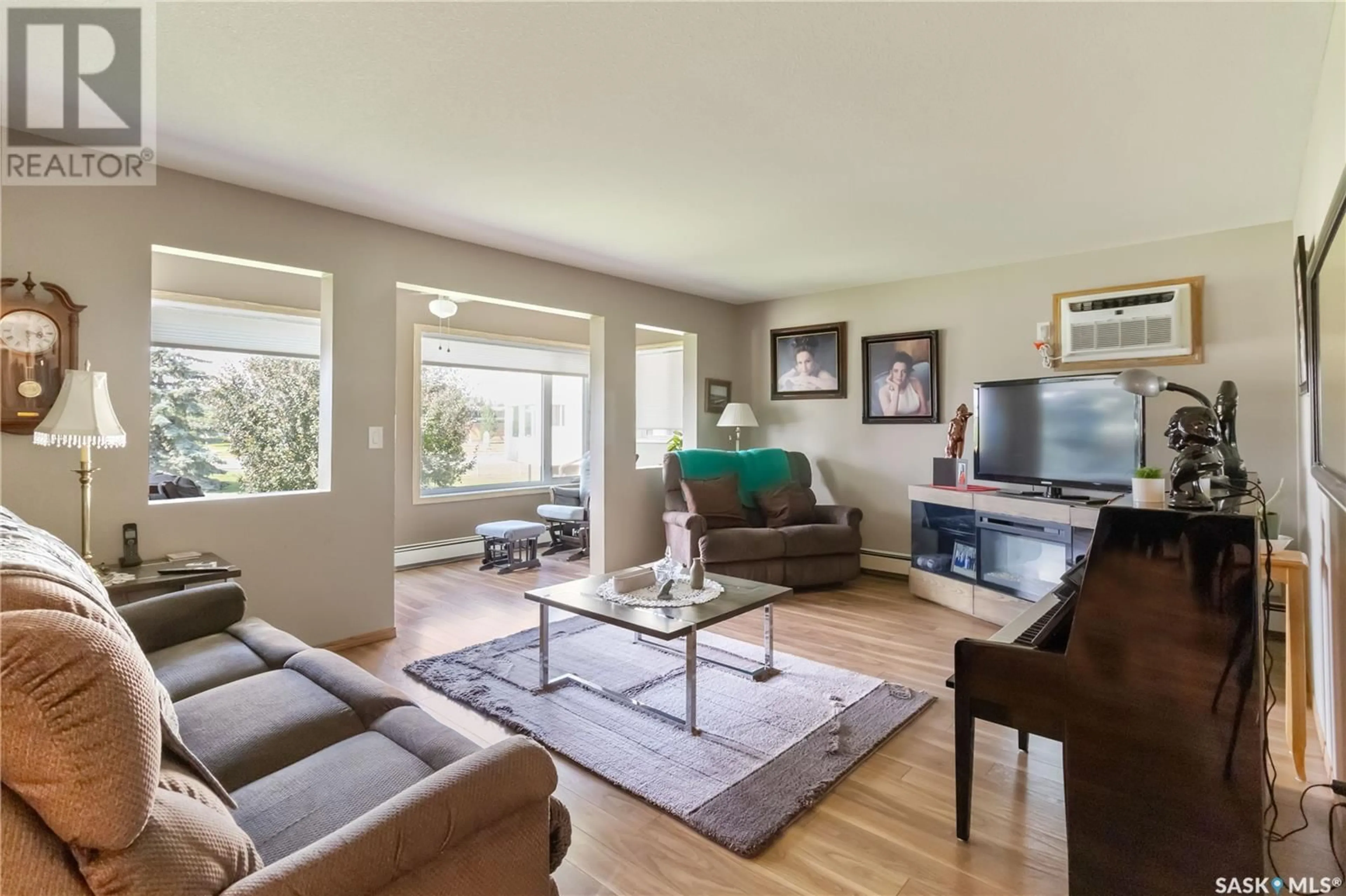 Living room with furniture, wood/laminate floor for 103 - 104 KEEVIL CRESCENT, Saskatoon Saskatchewan S7N4L9