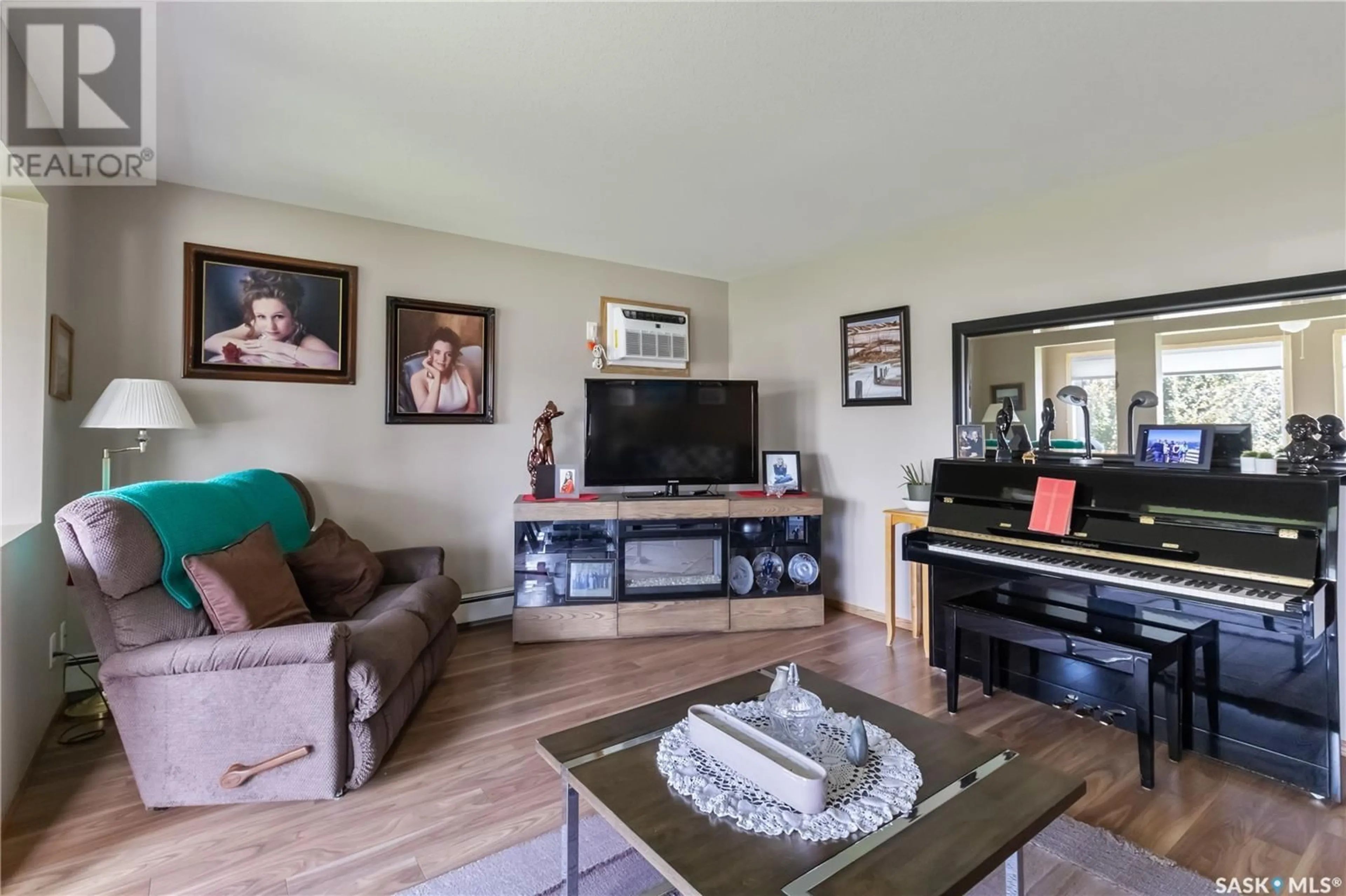 Living room with furniture, wood/laminate floor for 103 - 104 KEEVIL CRESCENT, Saskatoon Saskatchewan S7N4L9