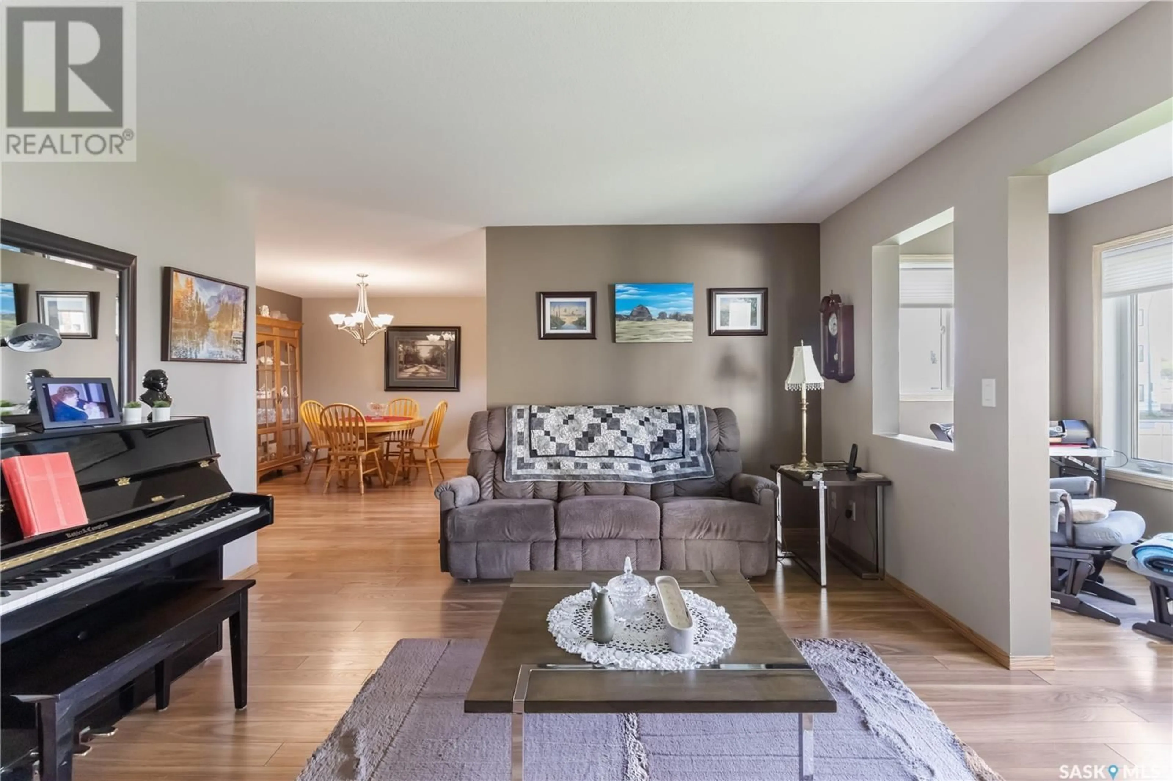 Living room with furniture, wood/laminate floor for 103 - 104 KEEVIL CRESCENT, Saskatoon Saskatchewan S7N4L9