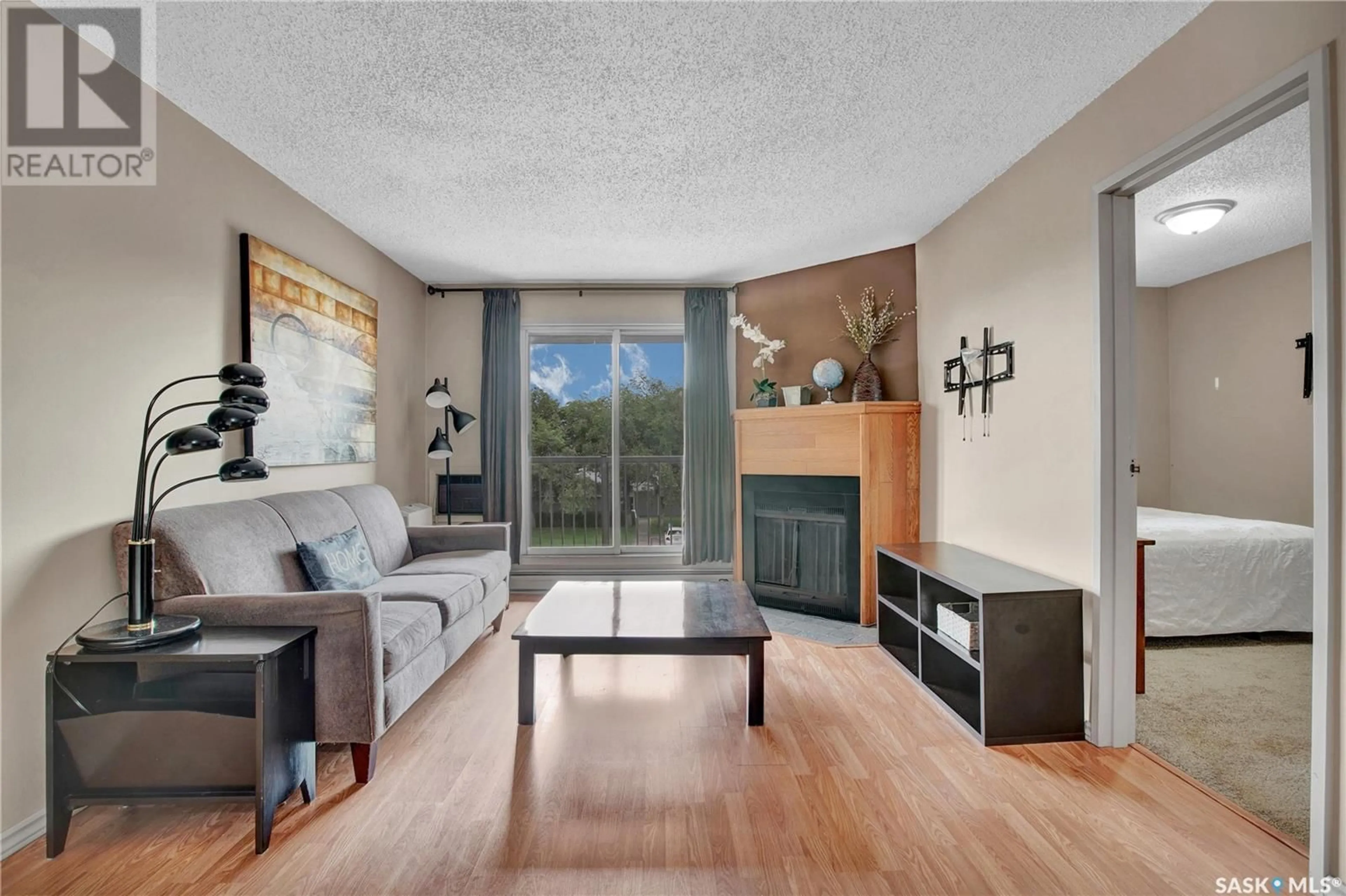 Living room with furniture, wood/laminate floor for 301A - 4040 8TH STREET, Saskatoon Saskatchewan S7H5L4