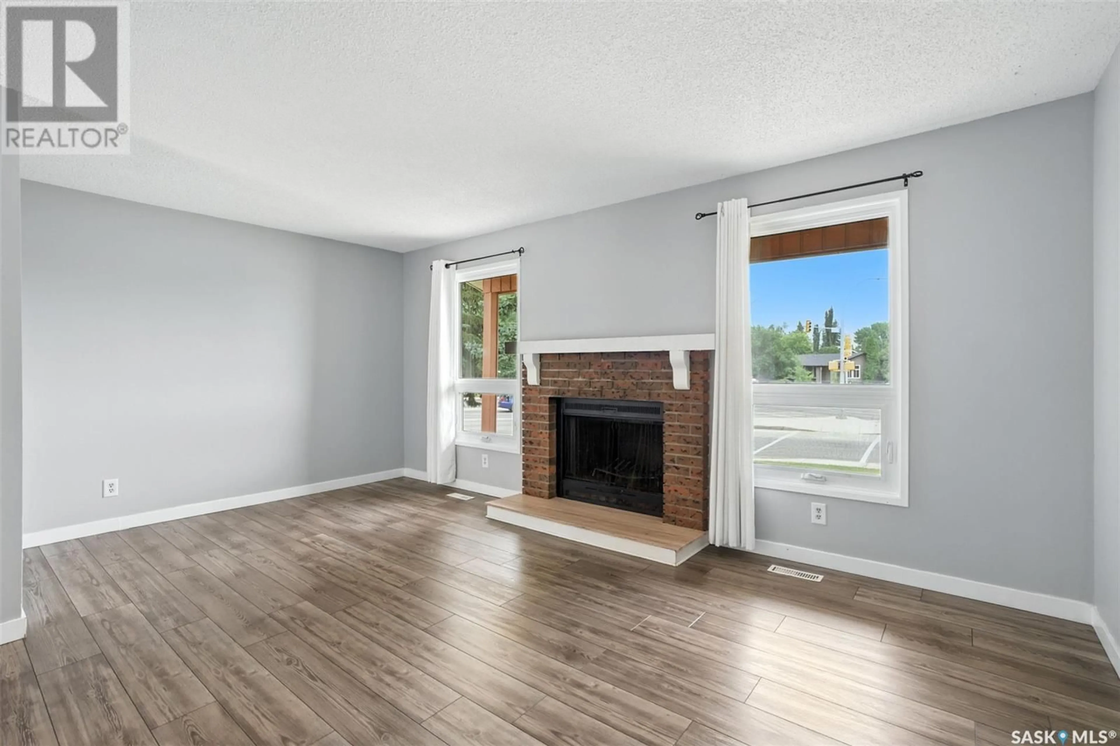 Living room with furniture, wood/laminate floor for 3921 TAYLOR STREET, Saskatoon Saskatchewan S7H5H5
