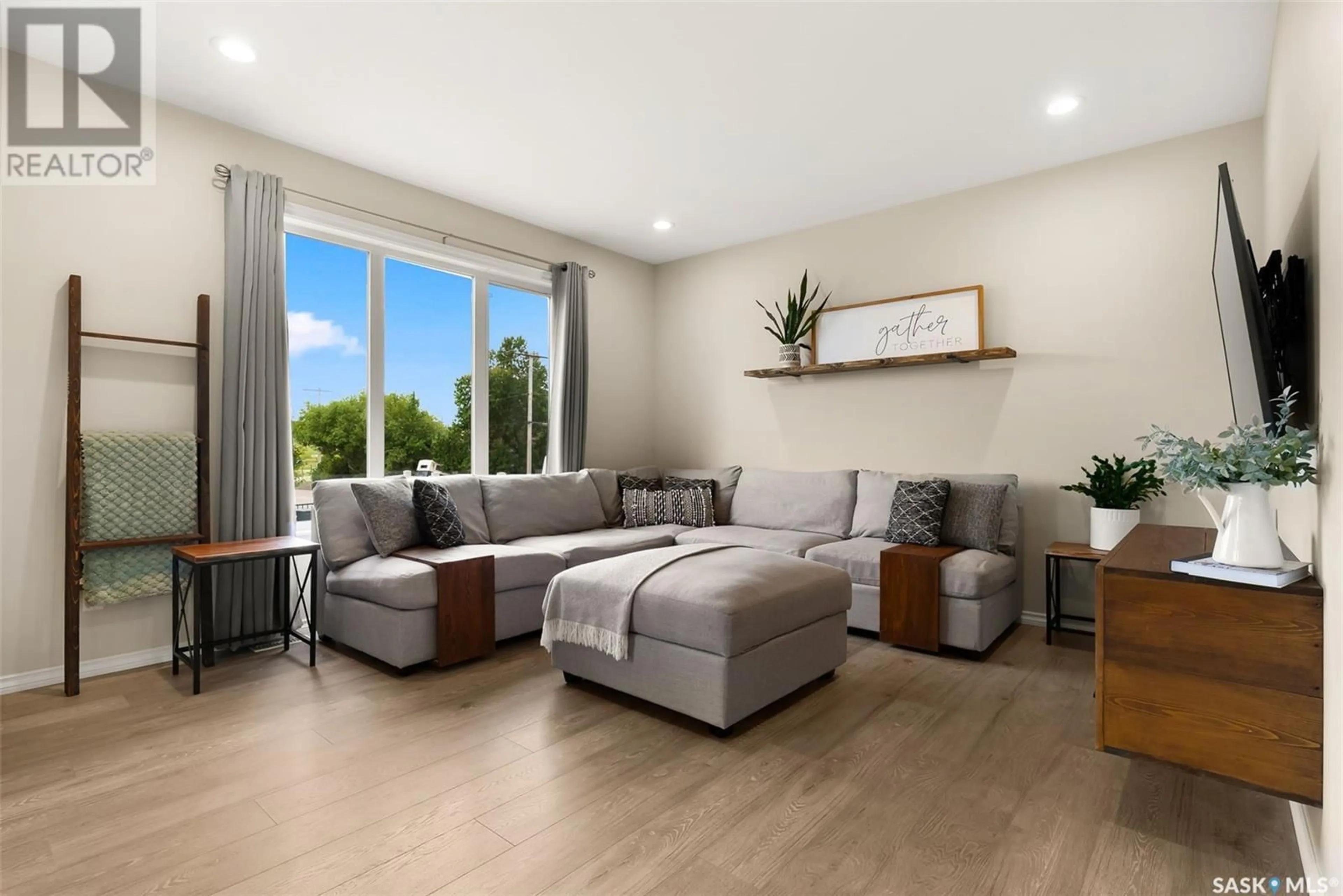 Living room with furniture, wood/laminate floor for 1 MACKENZIE ROAD, Pilot Butte Saskatchewan S0G3Z0