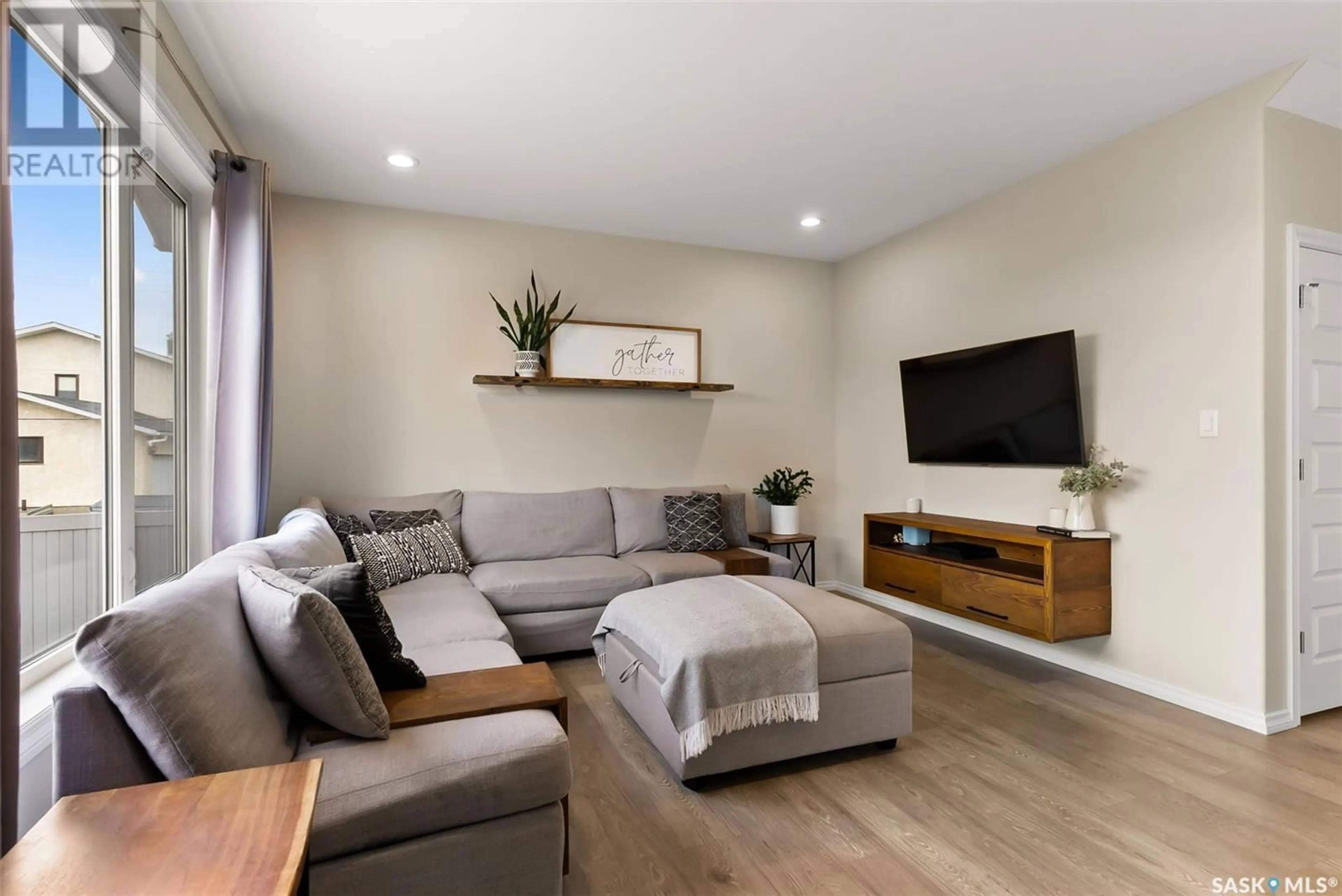 Living room with furniture, wood/laminate floor for 1 MACKENZIE ROAD, Pilot Butte Saskatchewan S0G3Z0