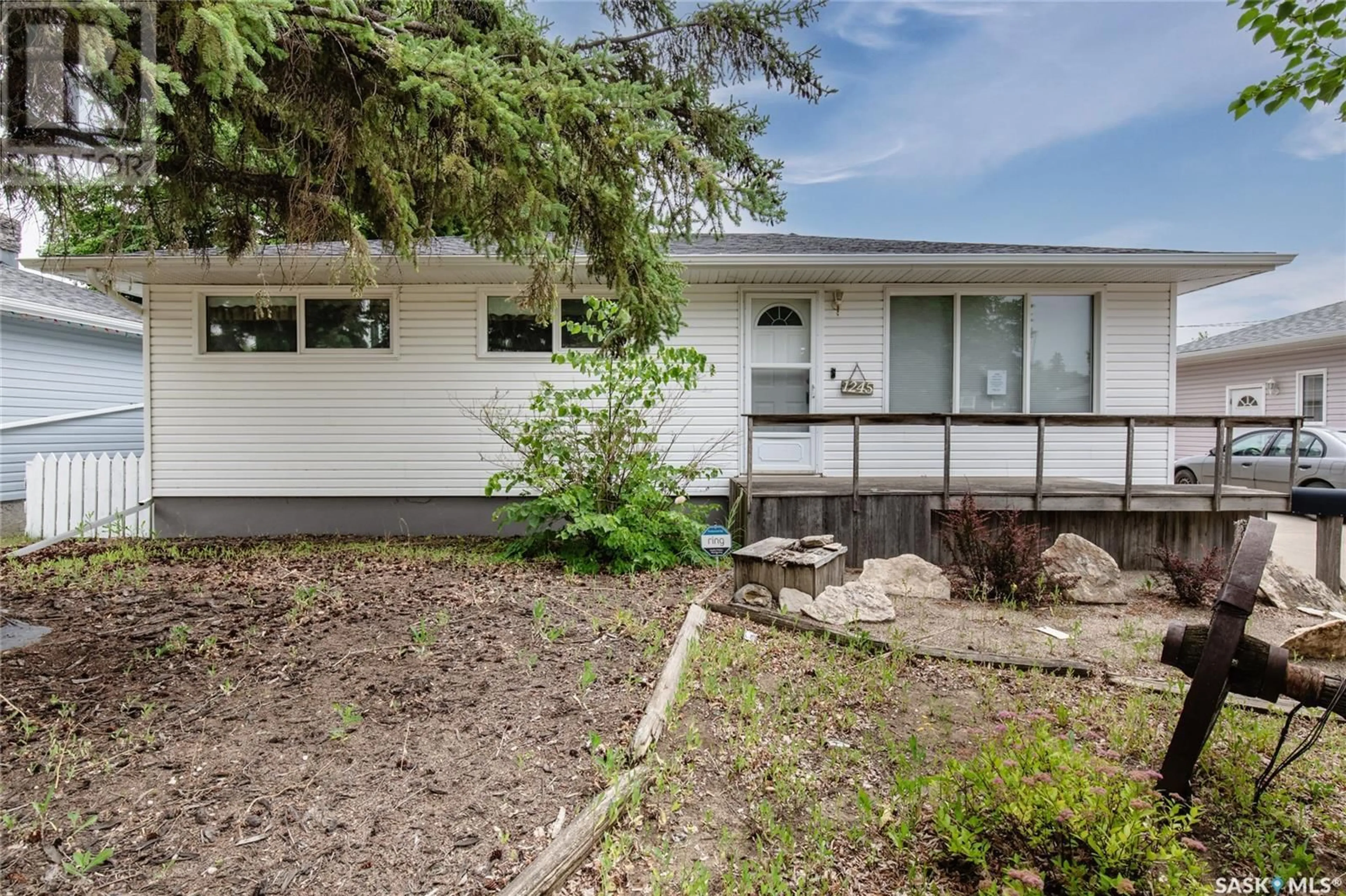 Home with vinyl exterior material, street for 1245 GRACE STREET, Moose Jaw Saskatchewan S6H3C6