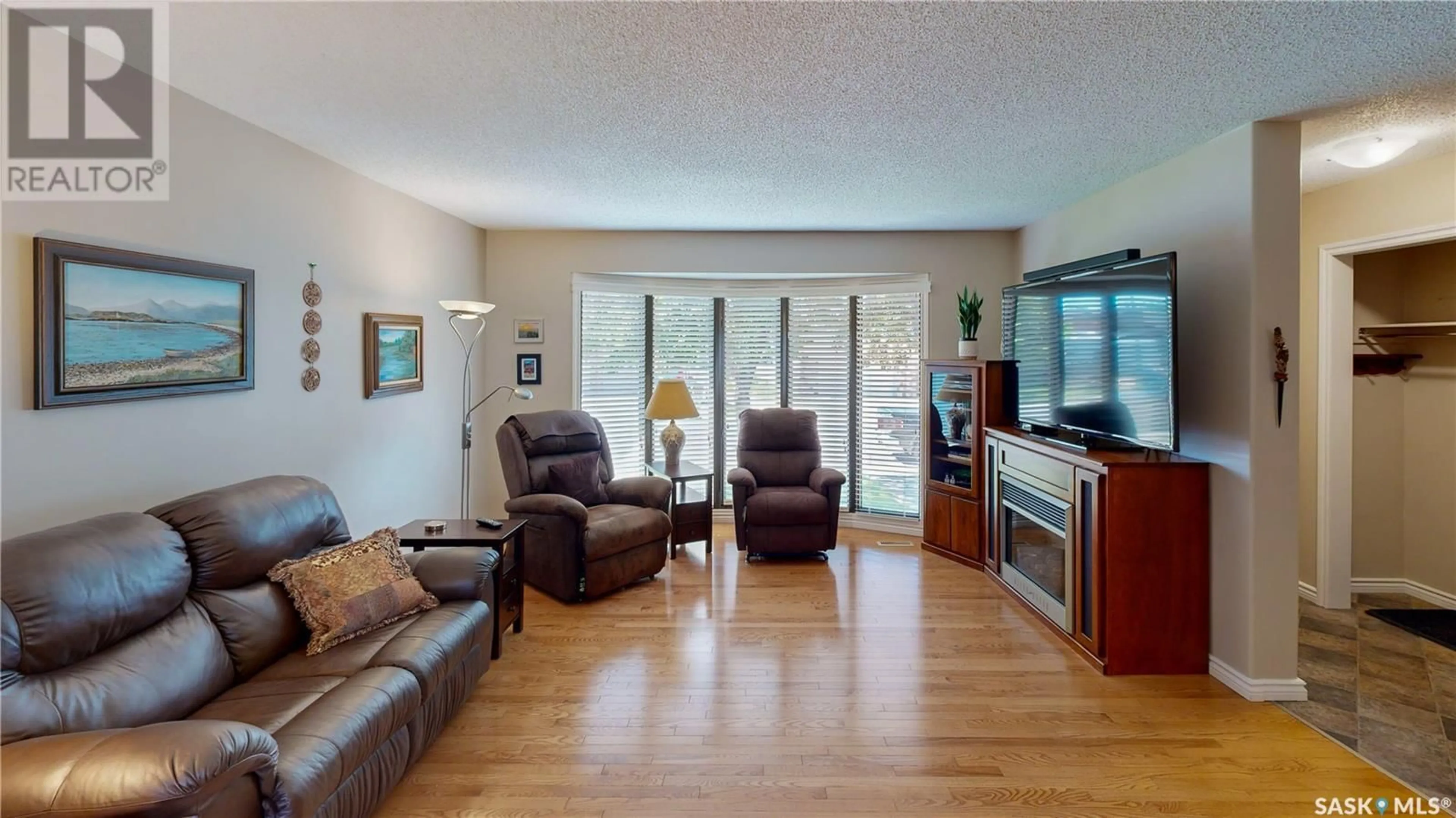 Living room with furniture, wood/laminate floor for 70 HAWKES AVENUE, Regina Saskatchewan S4X1B4