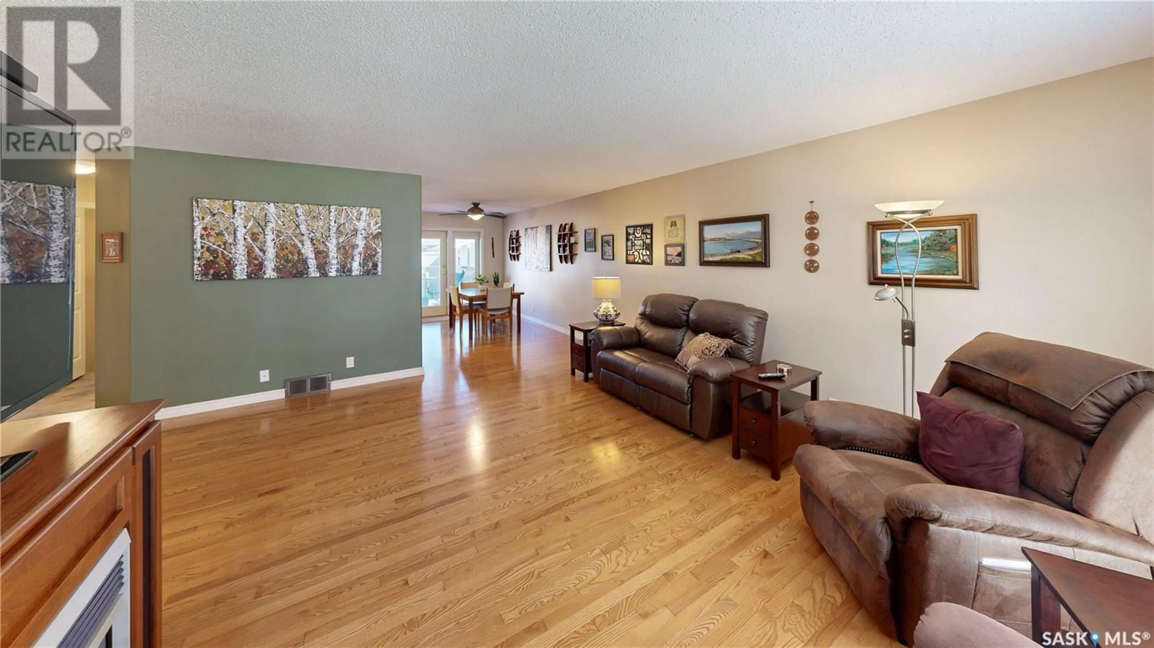 Living room with furniture, wood/laminate floor for 70 HAWKES AVENUE, Regina Saskatchewan S4X1B4