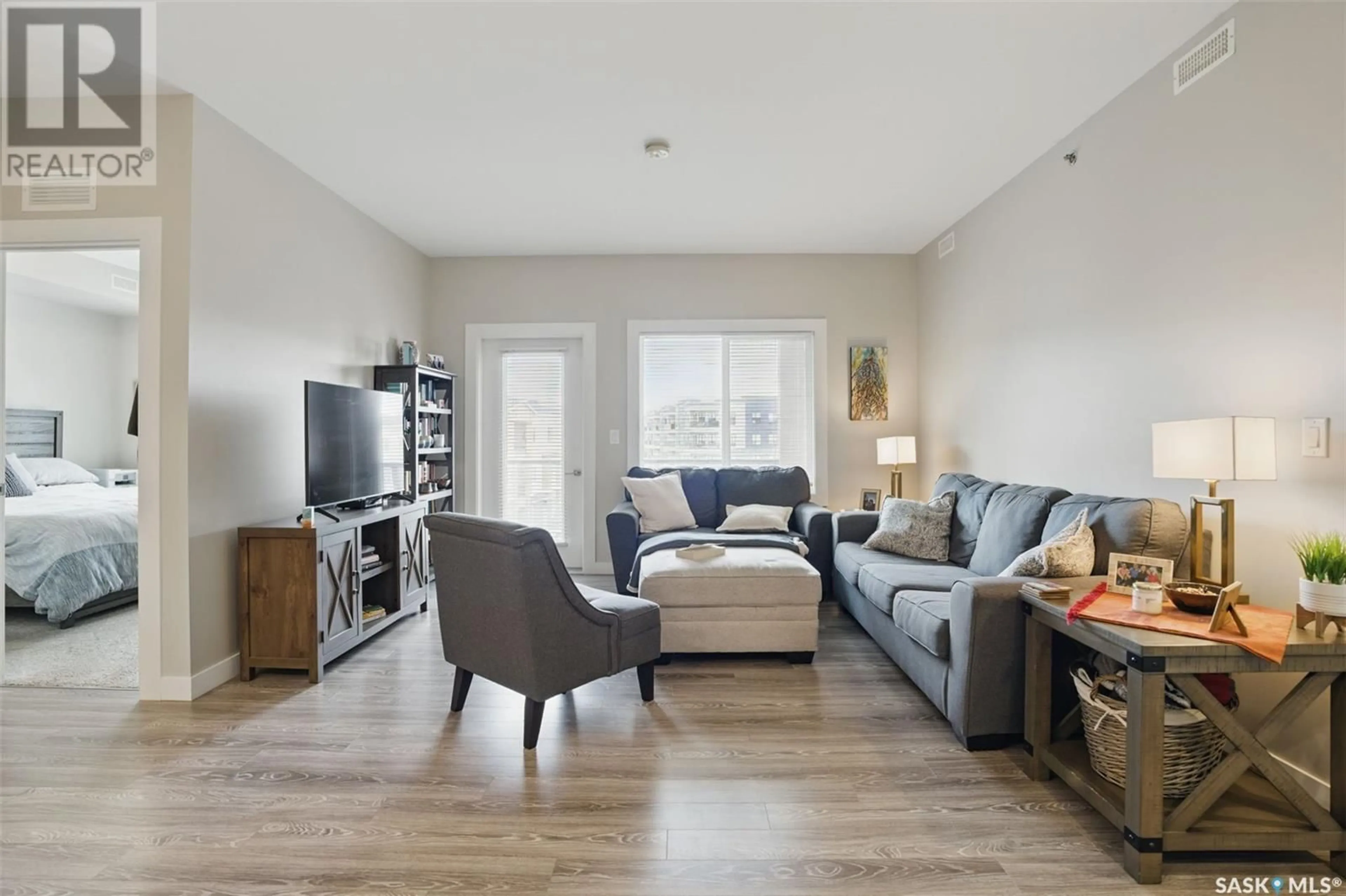 Living room with furniture, wood/laminate floor for 319 142 PAWLYCHENKO LANE, Saskatoon Saskatchewan S7V0N7