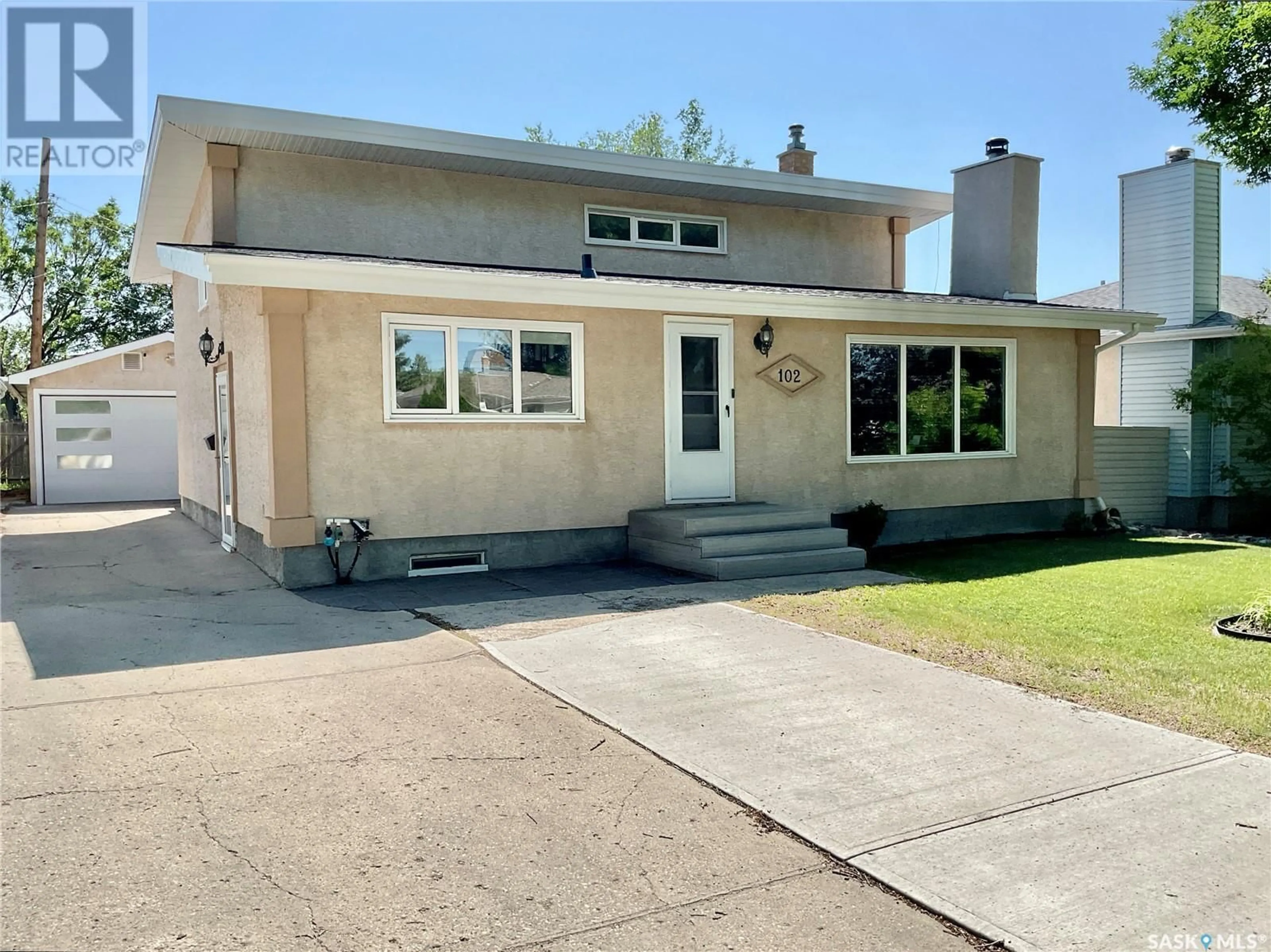 Home with vinyl exterior material, street for 102 MCINNIS CRESCENT, Regina Saskatchewan S4R3E8