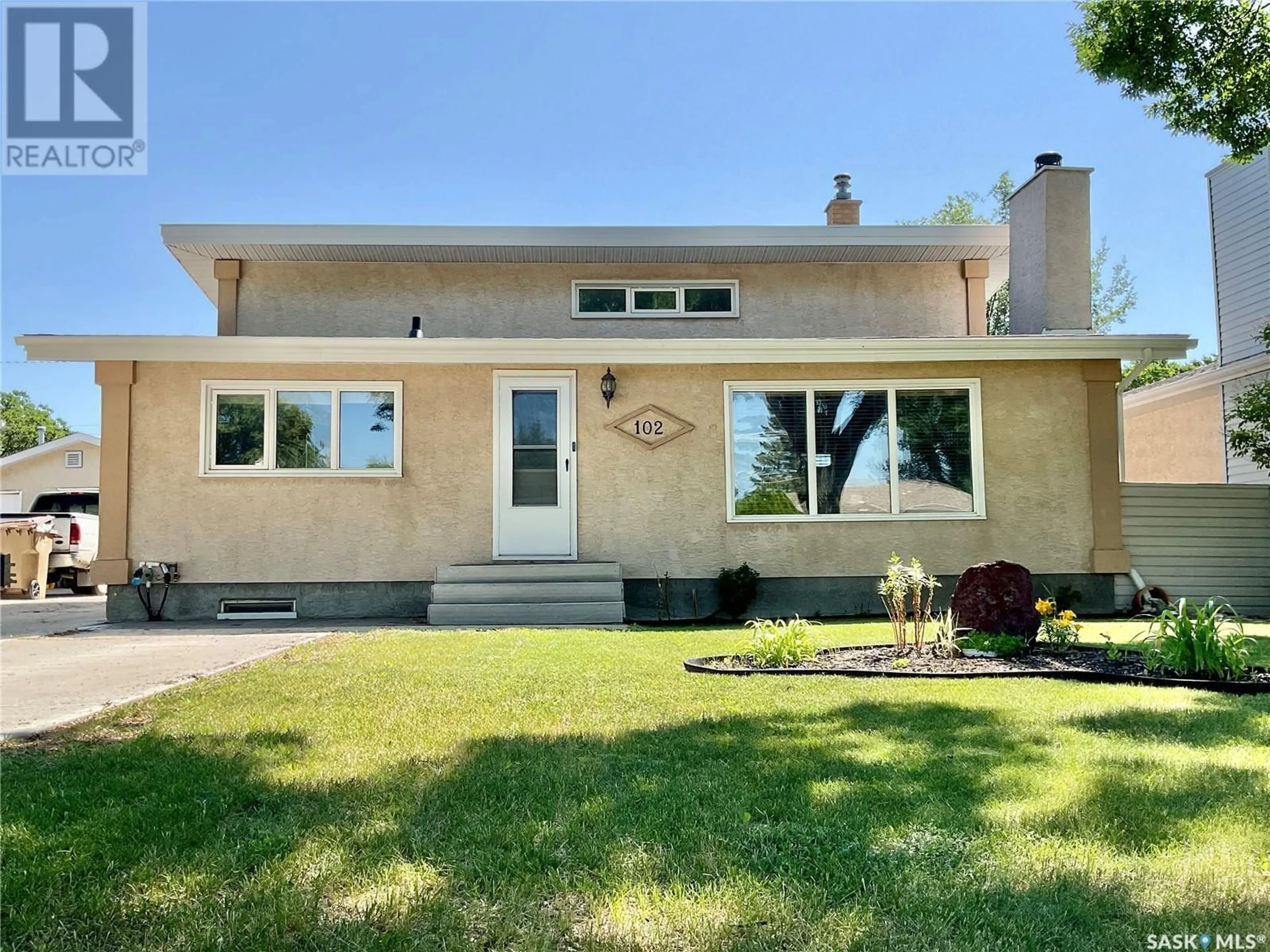 Home with vinyl exterior material, street for 102 MCINNIS CRESCENT, Regina Saskatchewan S4R3E8