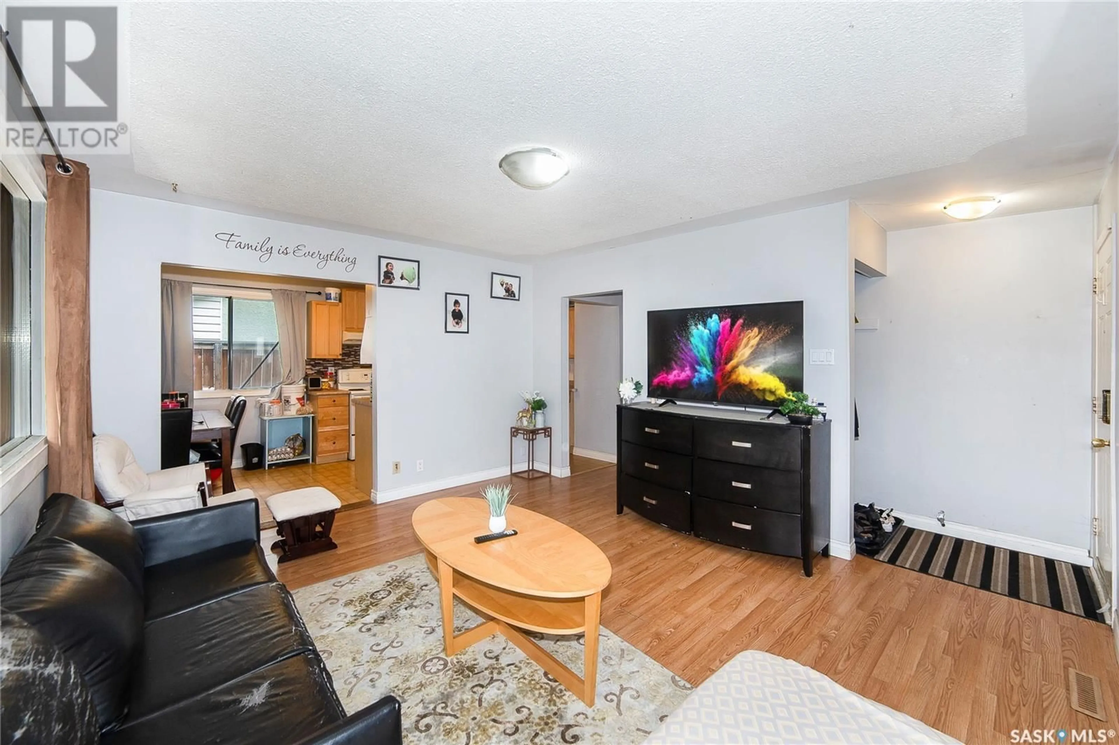 Living room with furniture, wood/laminate floor for 610 X AVENUE, Saskatoon Saskatchewan S7L3K2
