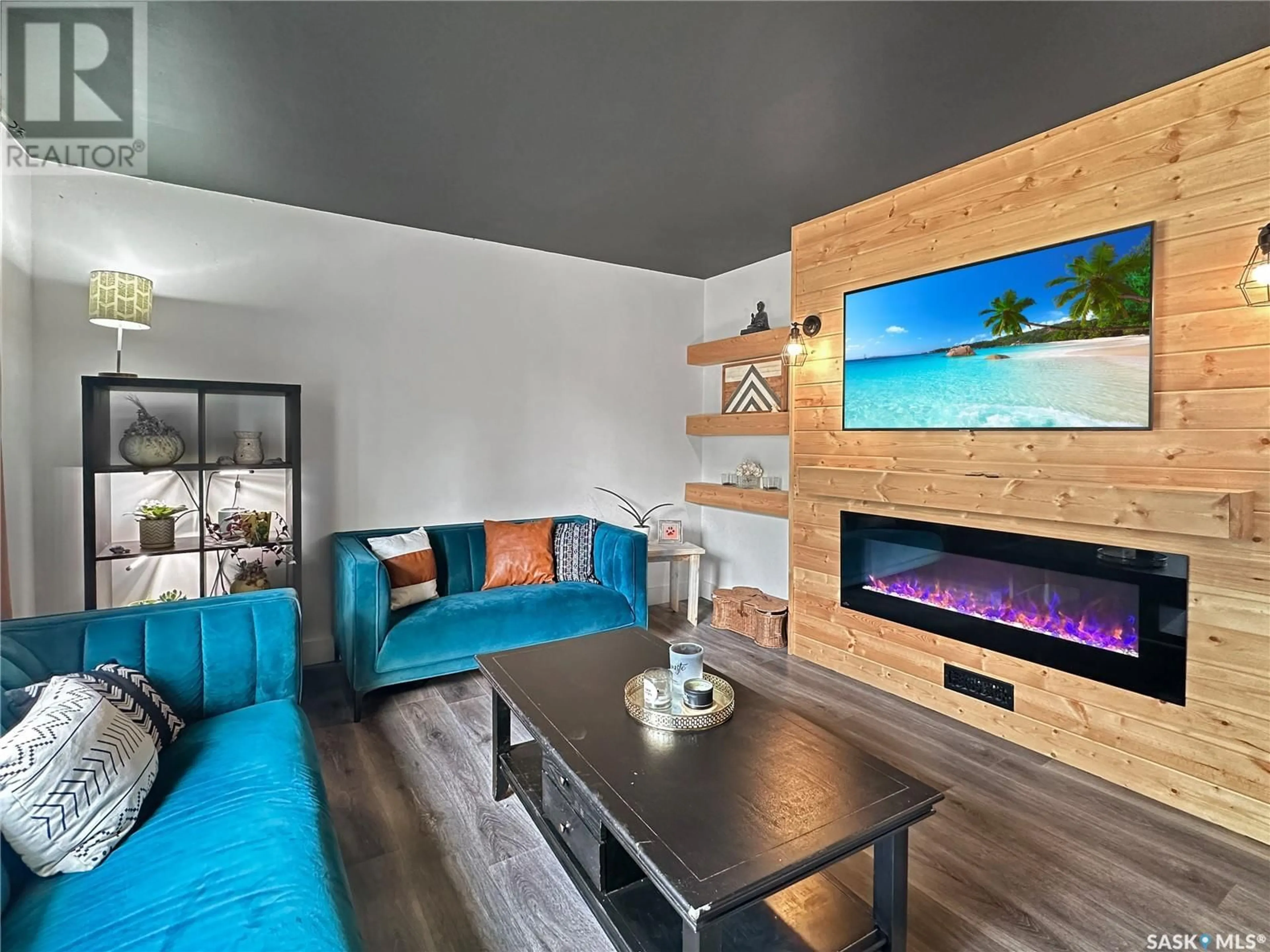 Living room with furniture, wood/laminate floor for 201 LILY STREET, Balcarres Saskatchewan S0G0C0