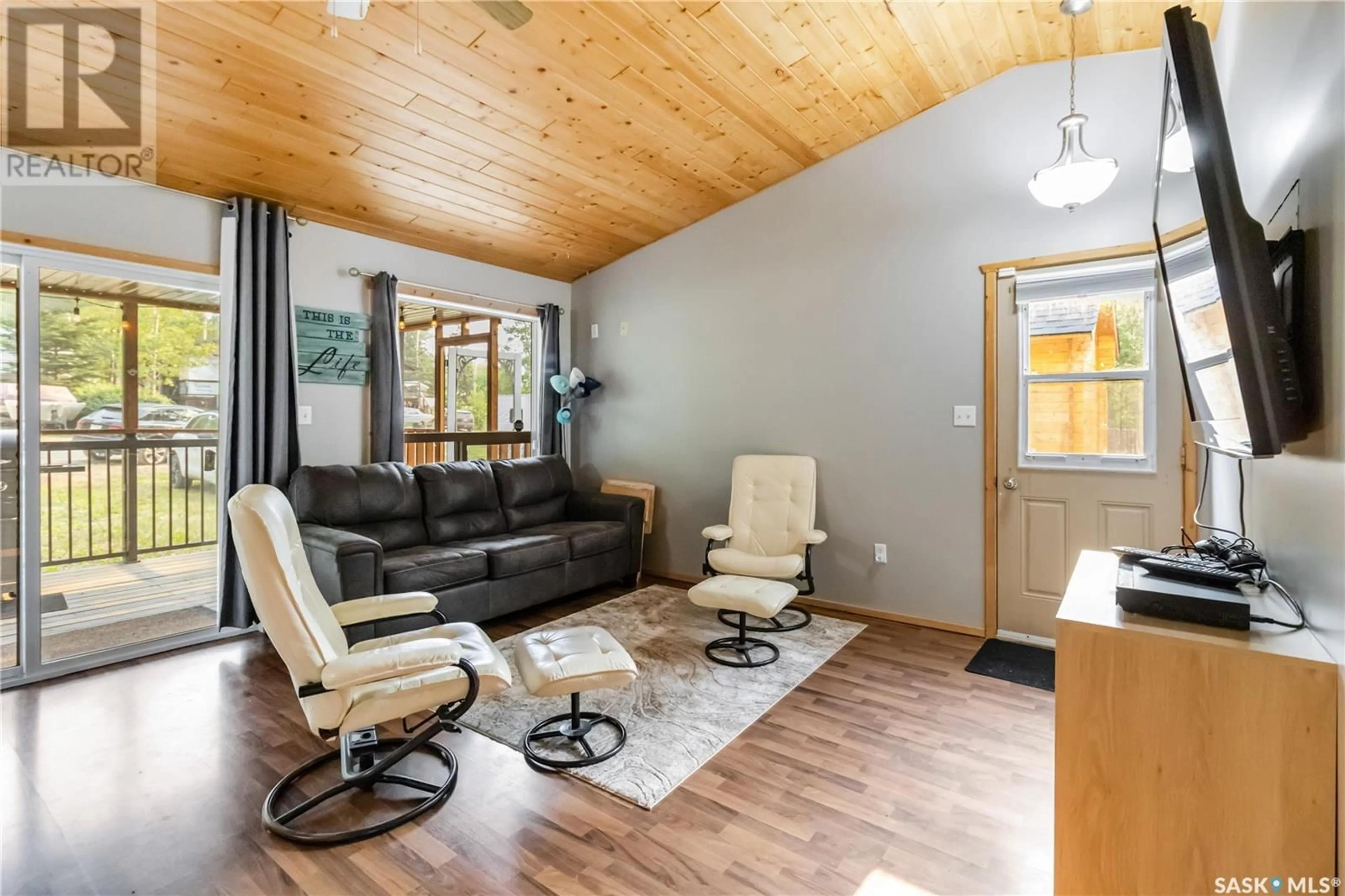 Living room with furniture, wood/laminate floor for 71 150 OKEMA BEACH ROAD, Lakeland Rm No. 521 Saskatchewan S0J0N0