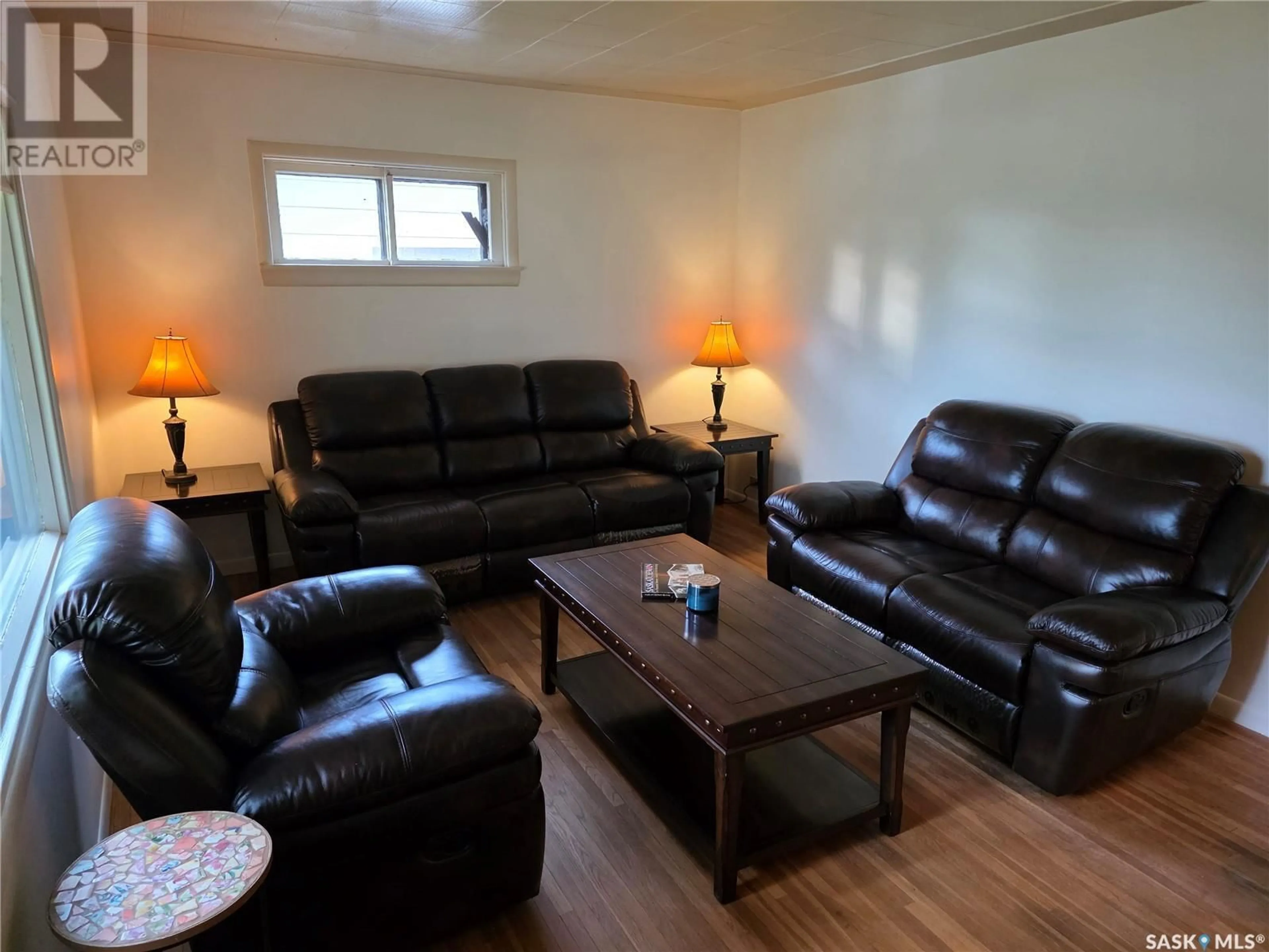 Living room with furniture, wood/laminate floor for 113 1ST STREET, Milden Saskatchewan S0L2L0