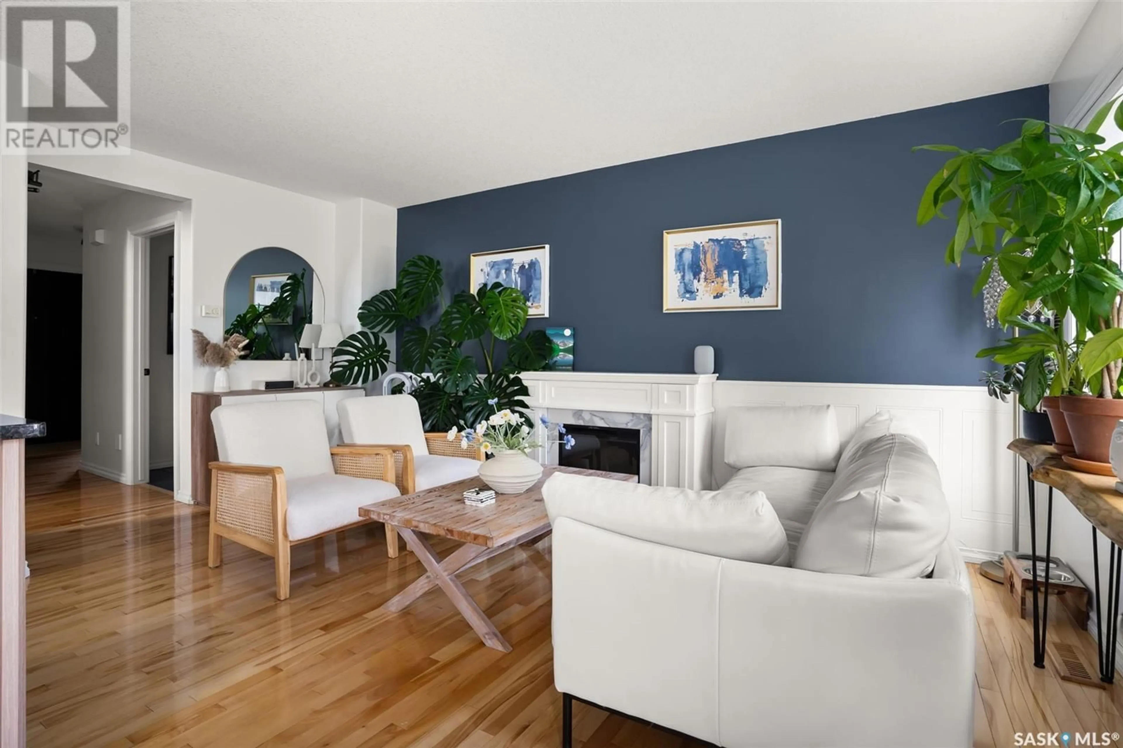 Living room with furniture, wood/laminate floor for 50 2400 TELL PLACE, Regina Saskatchewan S4V3E3