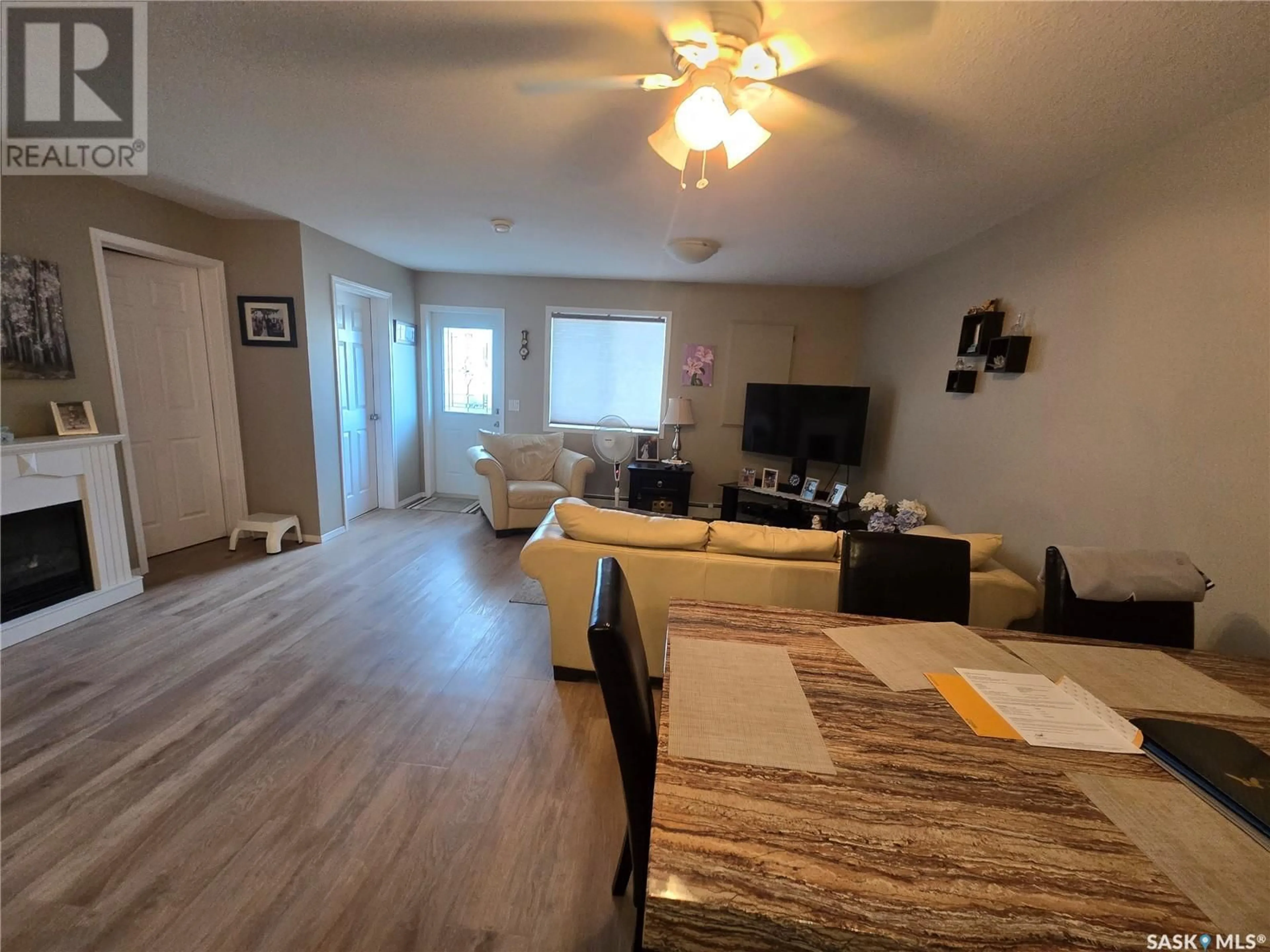 Living room with furniture, wood/laminate floor for 203 - 825 GLADSTONE STREET, Swift Current Saskatchewan S9H5P1