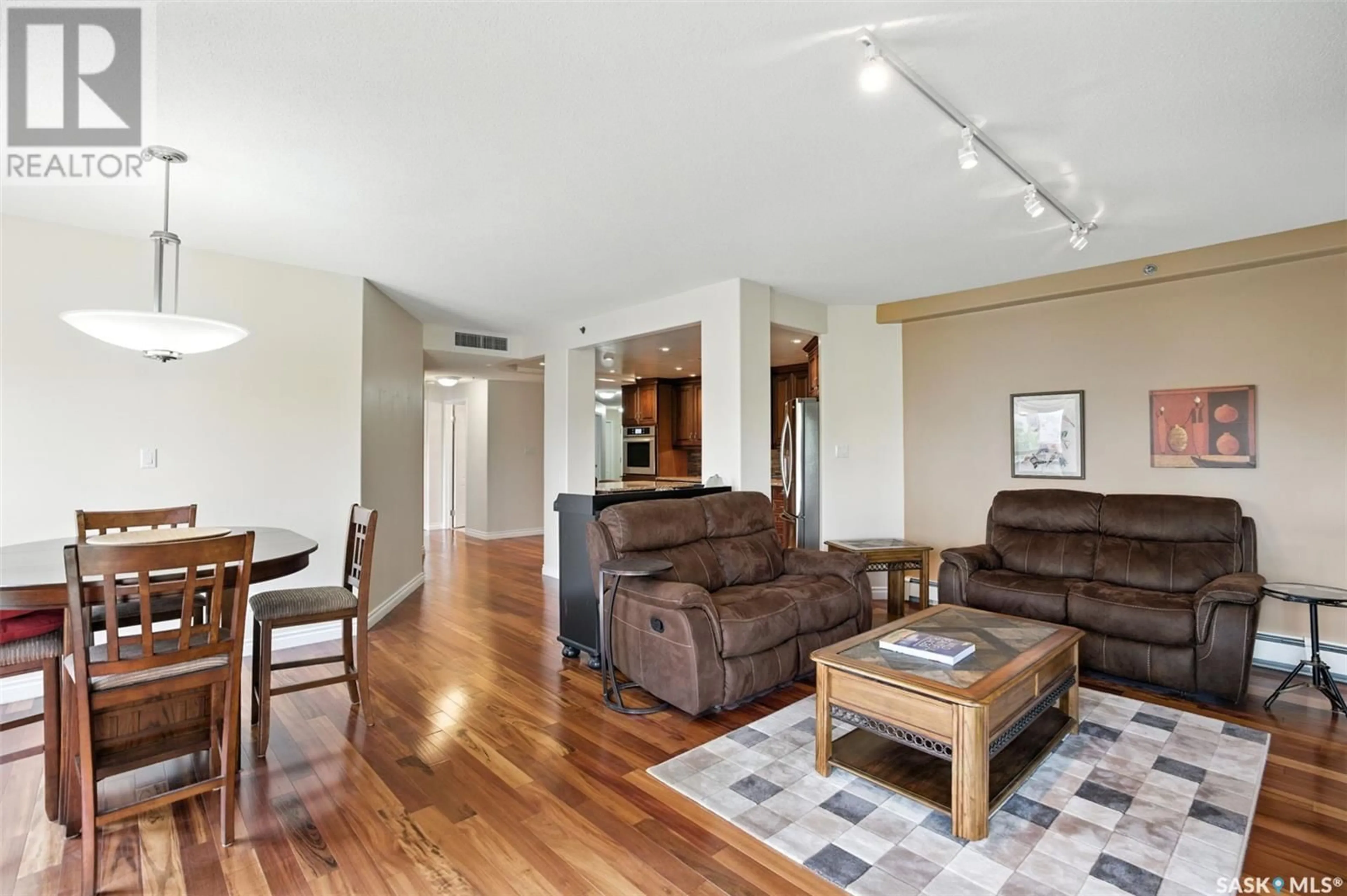 Living room with furniture, wood/laminate floor for 303 - 406 5TH AVENUE, Saskatoon Saskatchewan S7K2P6